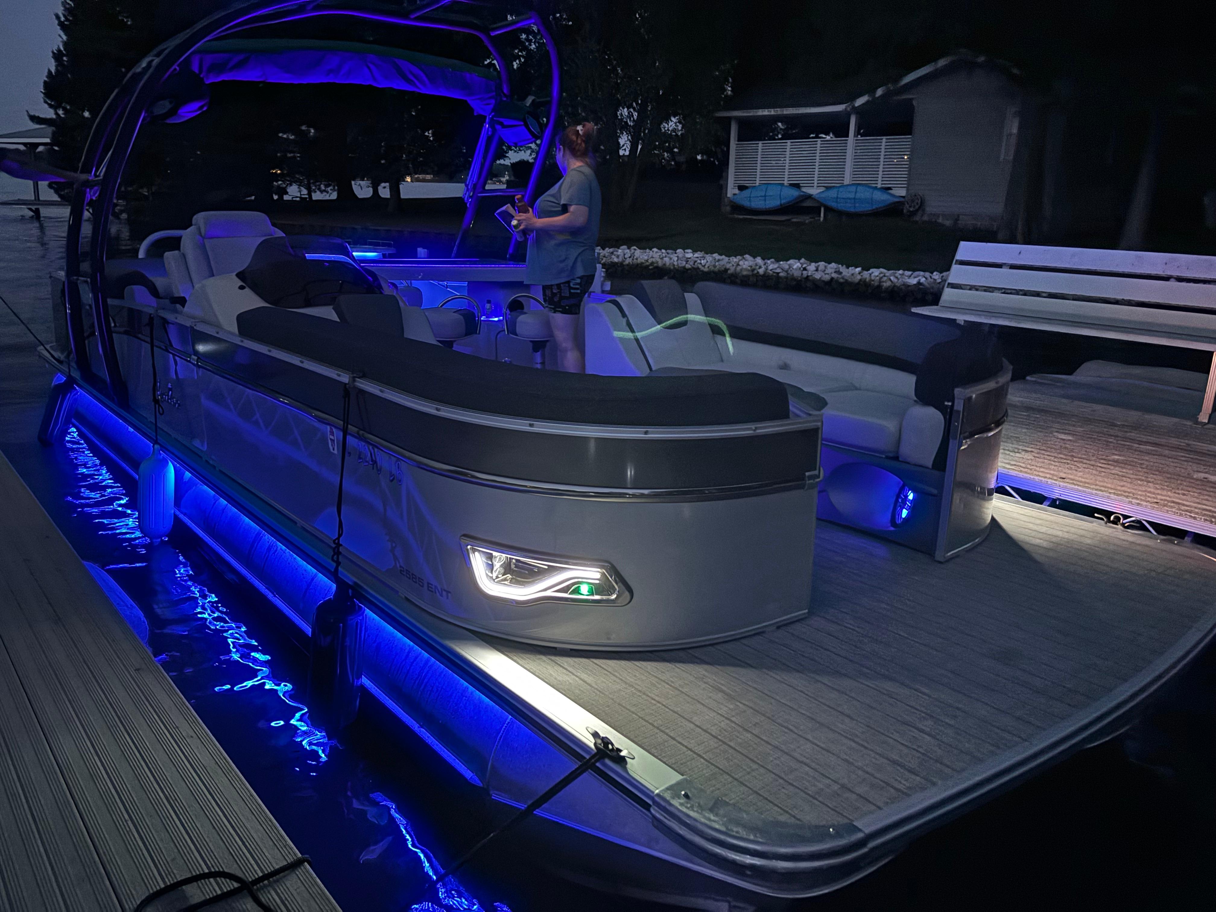 2021 Avalon Catalina Entertainer pontoon boat with blue LED lights at dock.