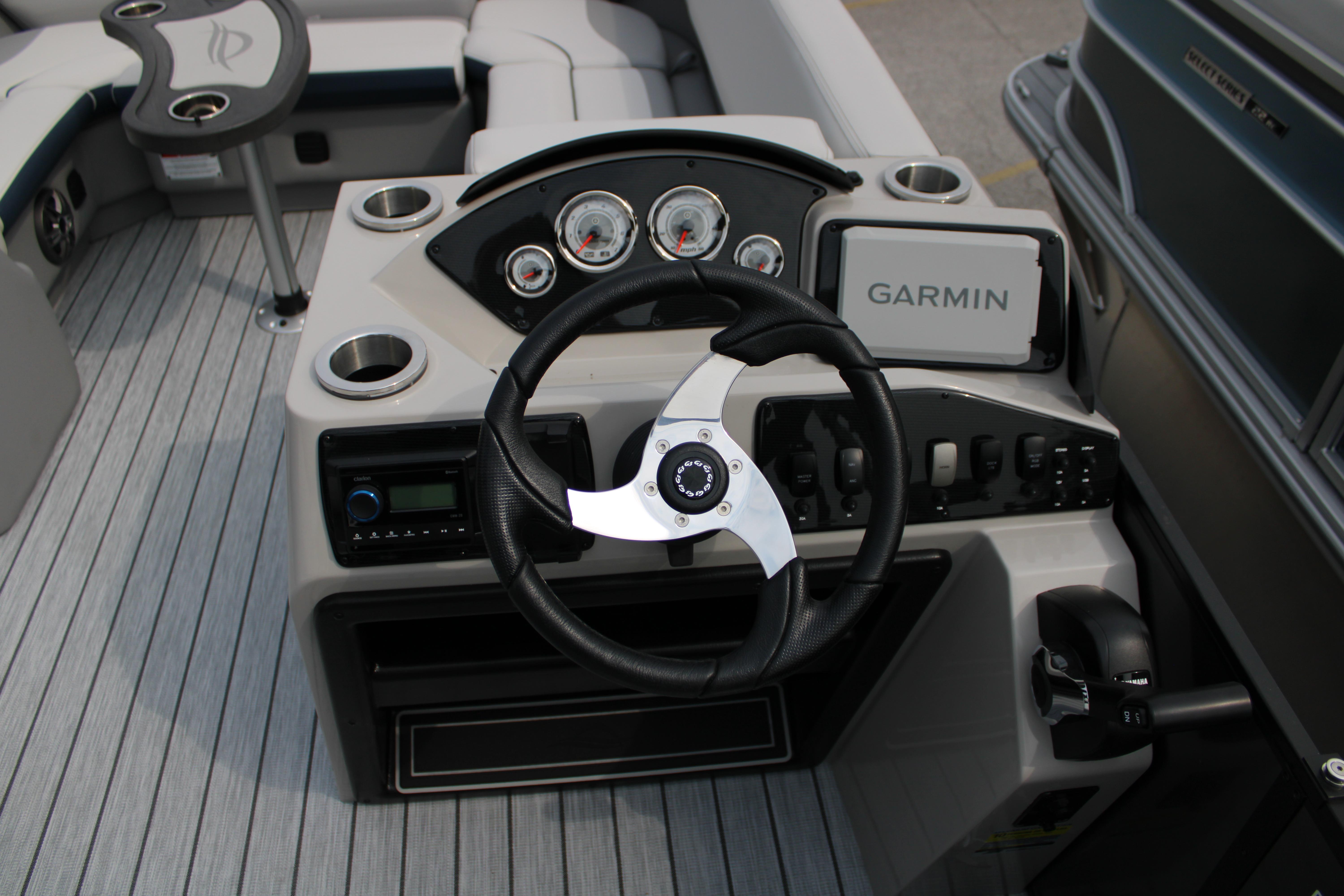 Cockpit of 2025 SunCatcher Select 320RCX boat with Garmin navigation system.