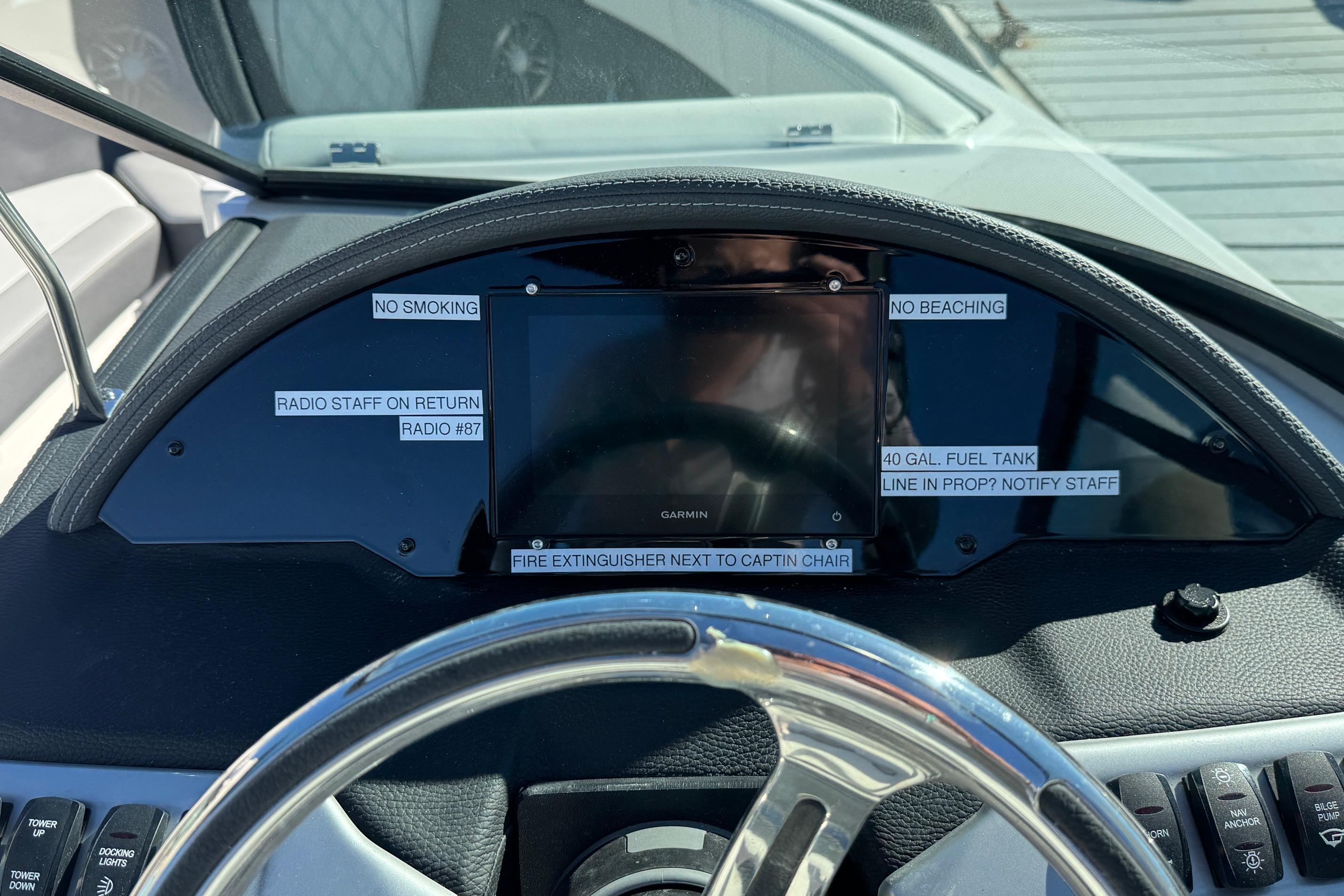 2026 Regal 21 OBX dashboard with safety labels and Garmin display.