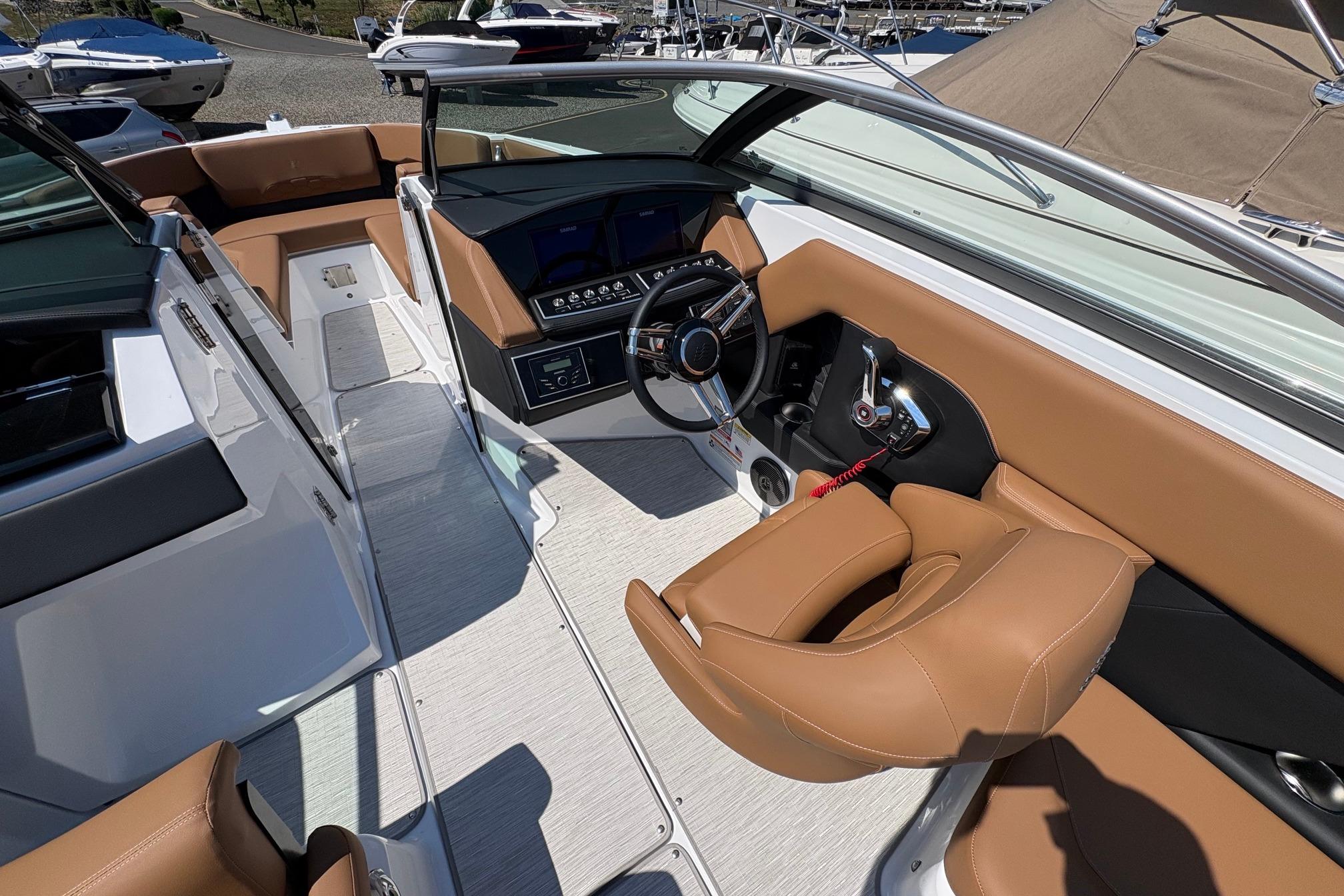Interior view of 2026 Four Winns H6 boat with modern dashboard and tan seating.