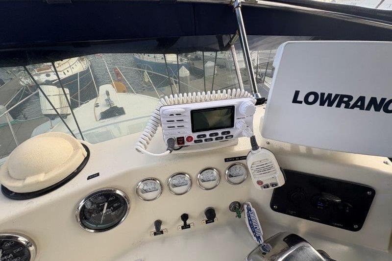 1987 Tollycraft 34 Sundeck Motor Yacht helm with gauges and Lowrance equipment.
