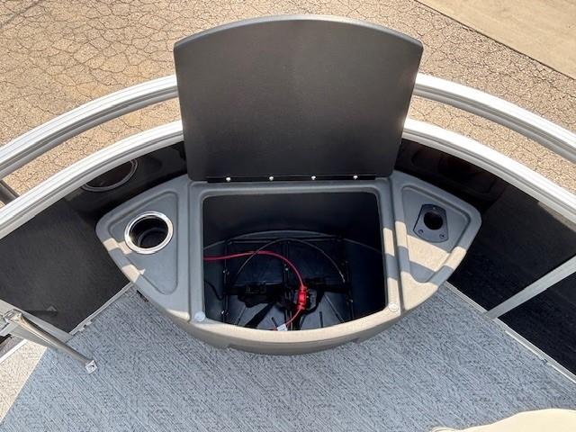 2026 Sun Tracker Fishin' Barge 20 DLX storage compartment with cup holders and wiring.