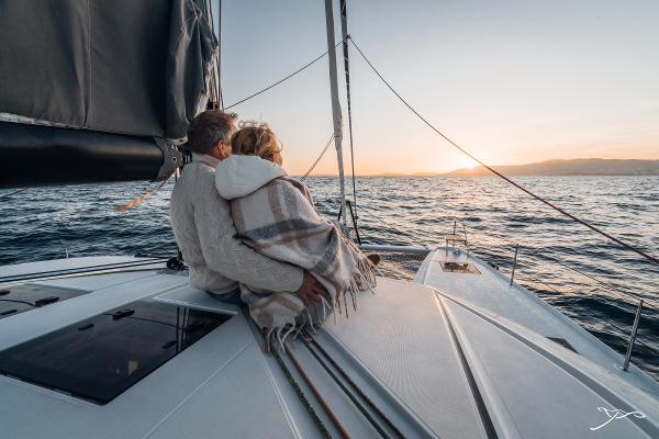 Couple enjoying sunset on 2025 Nautitech 44 Open yacht deck.