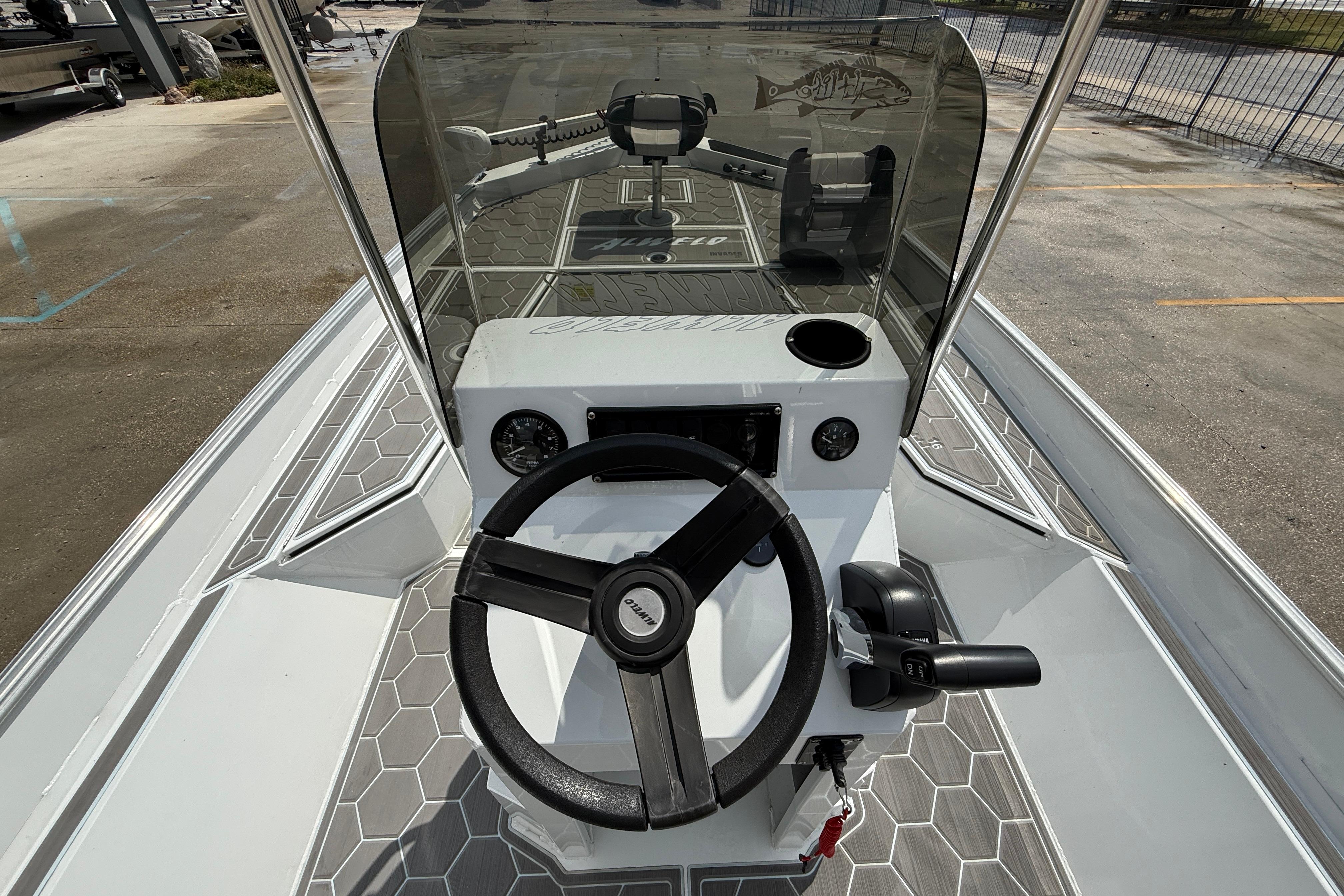 2024 Alweld 2070cc boat console with steering wheel and controls, featuring hexagonal flooring.