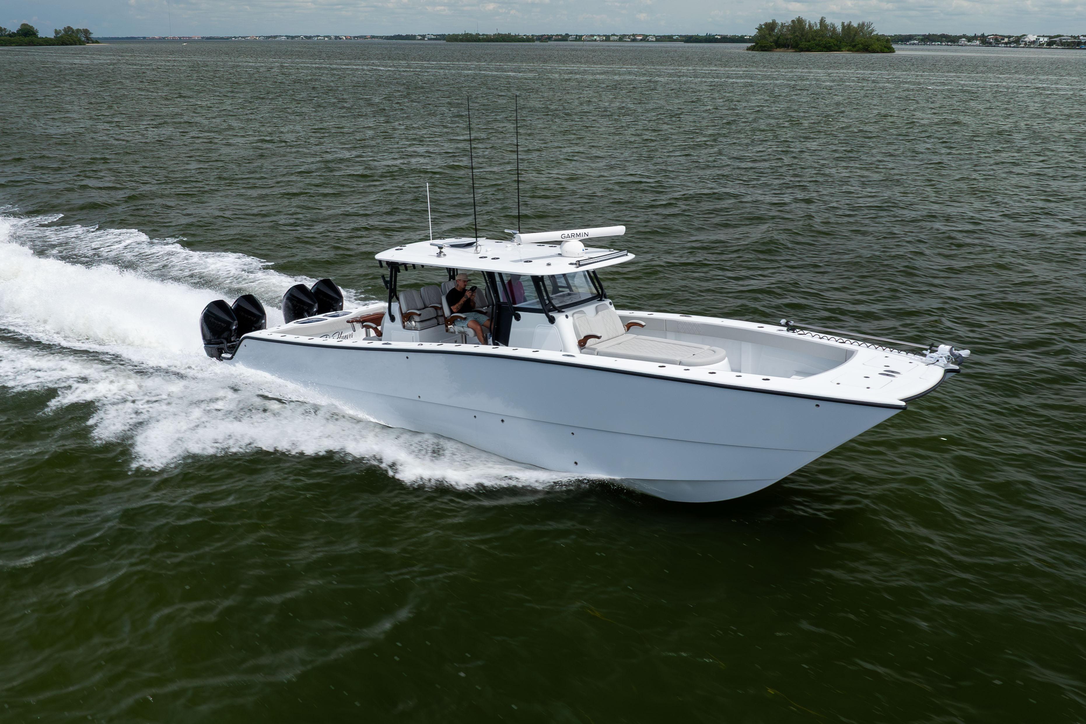 2025 Freeman 42 LR boat cruising on open water with four engines.