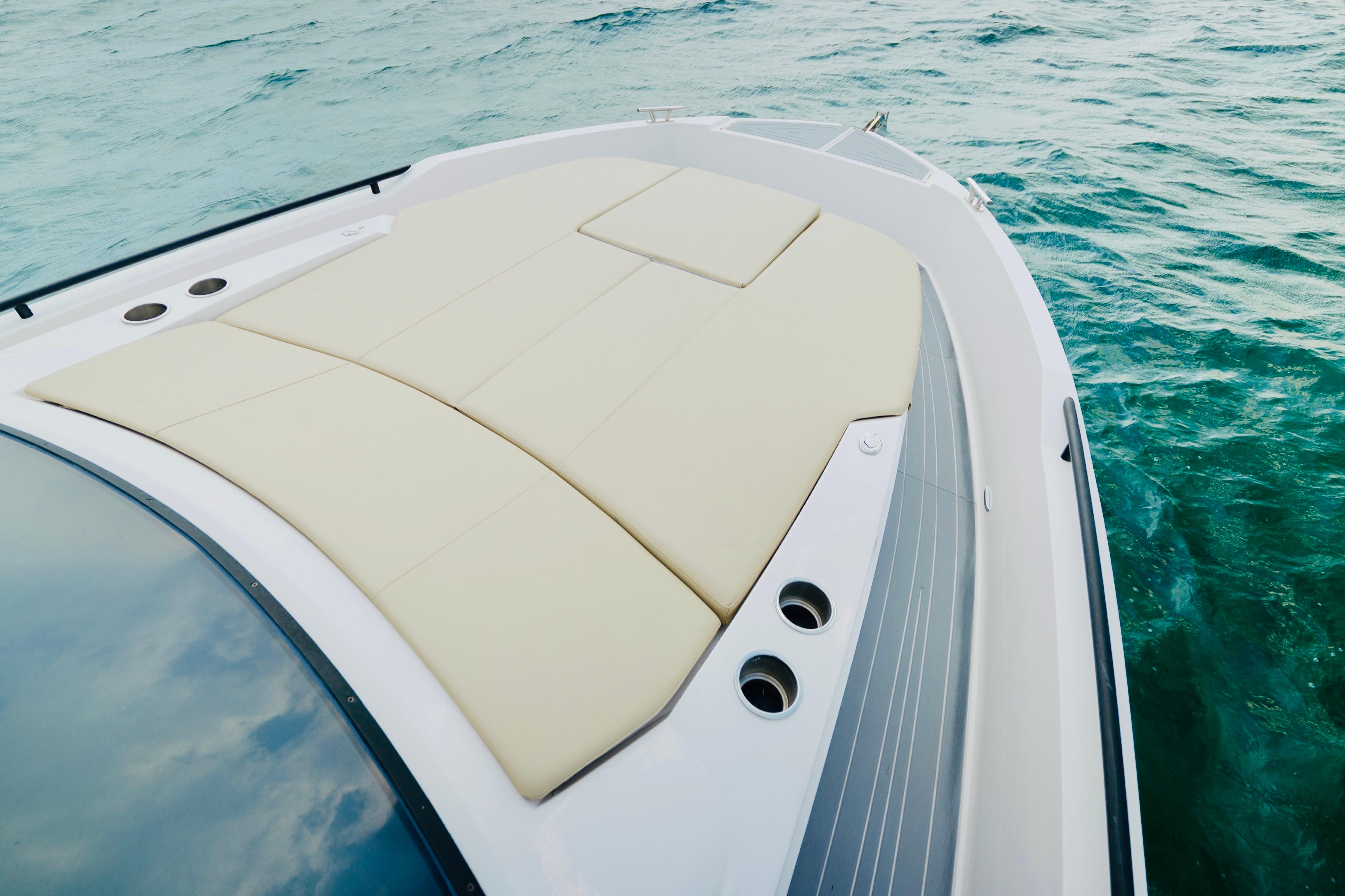 2023 Rio Yachts Daytona 34 bow with sunpad, cruising on clear blue water.