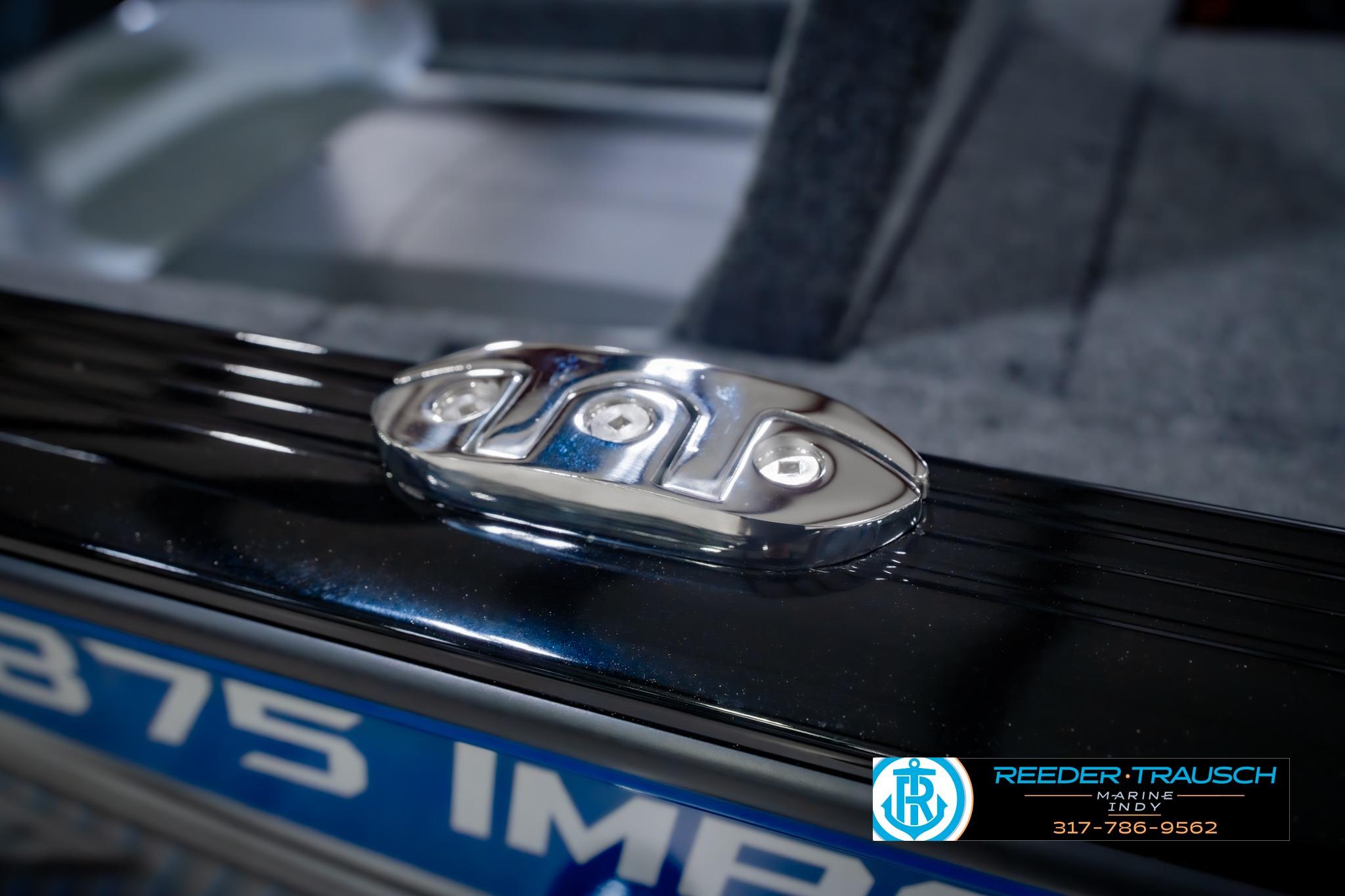 2026 Lund 1875 Impact XS boat detail with chrome hardware and branding.