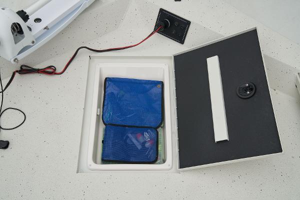 Manufacturer Provided Image: Manufacturer Provided Image: Ranger RB210 2025 boat storage compartment with blue bag and wiring.