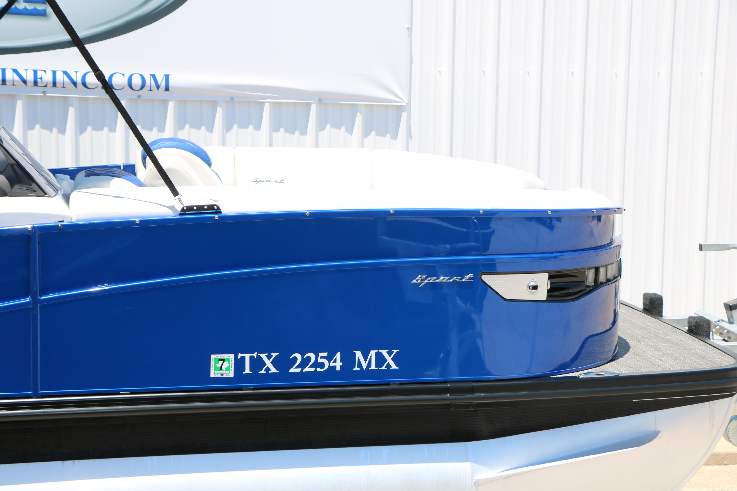 2024 Bennington 23 RX Swingback boat, blue exterior, docked with registration TX 2254 MX.