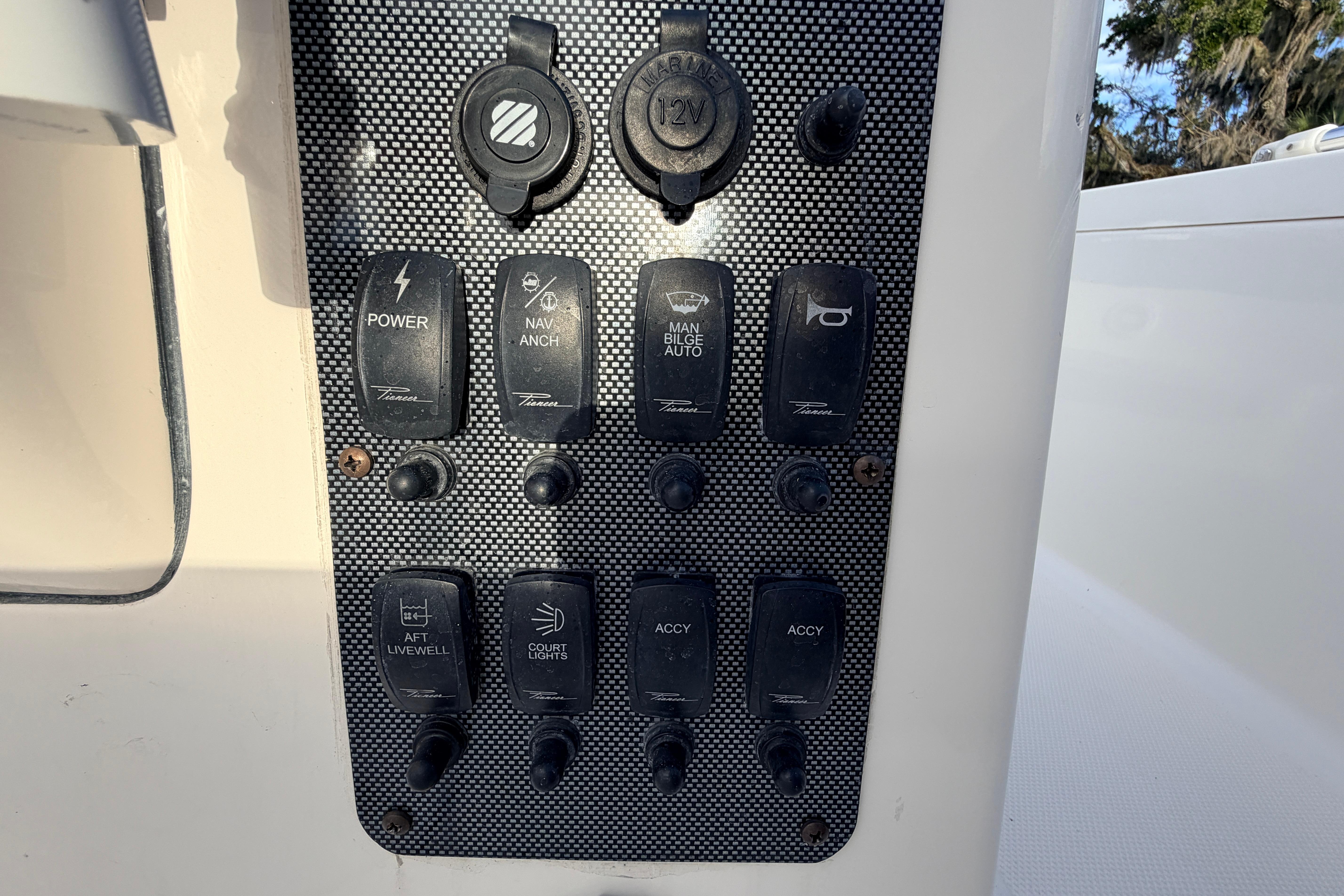 Control panel of a 2015 Pioneer 186 Cape Island boat with various switches.