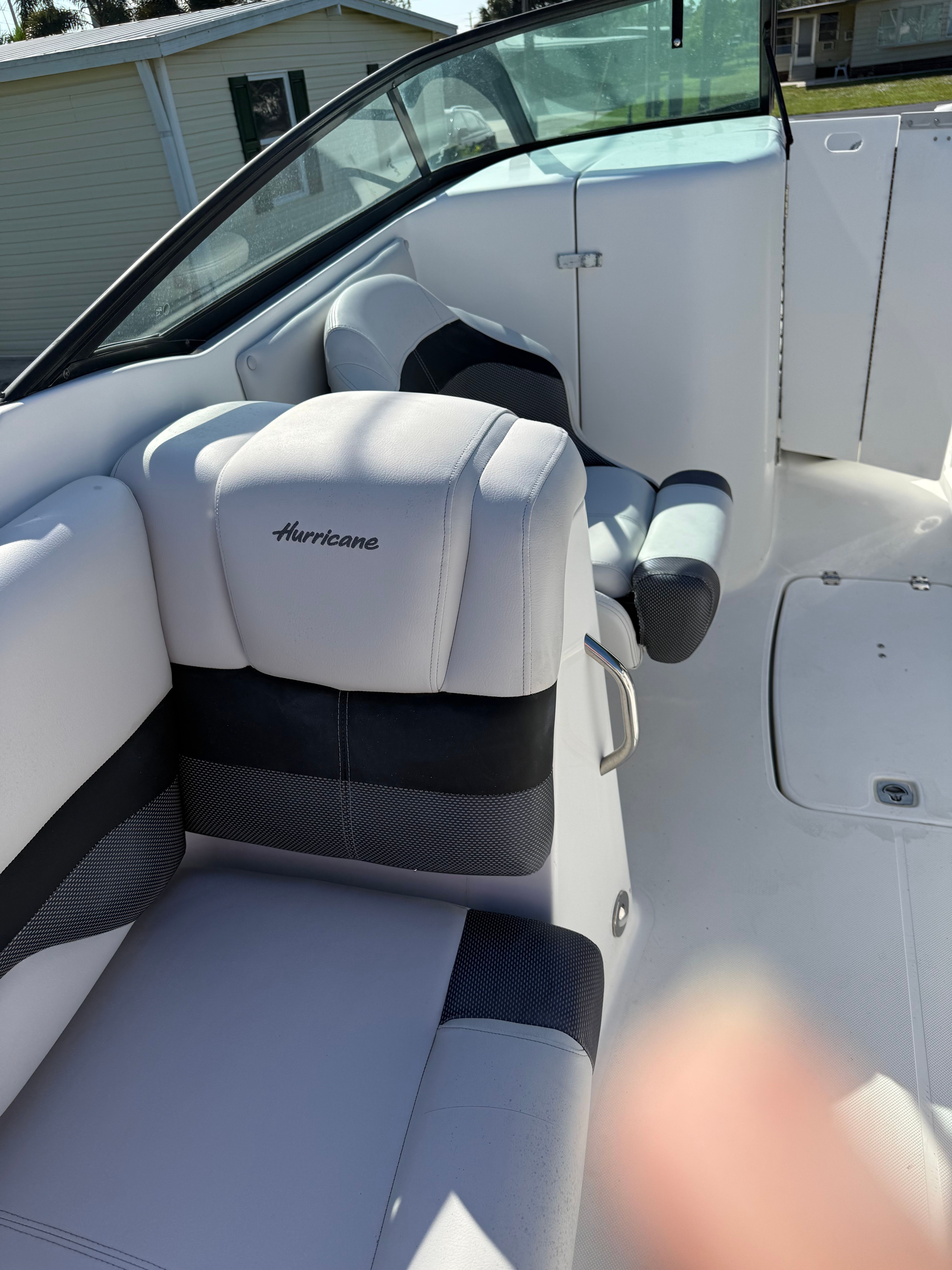 Interior of a 2018 Hurricane SunDeck 2690 OB boat, white upholstery.