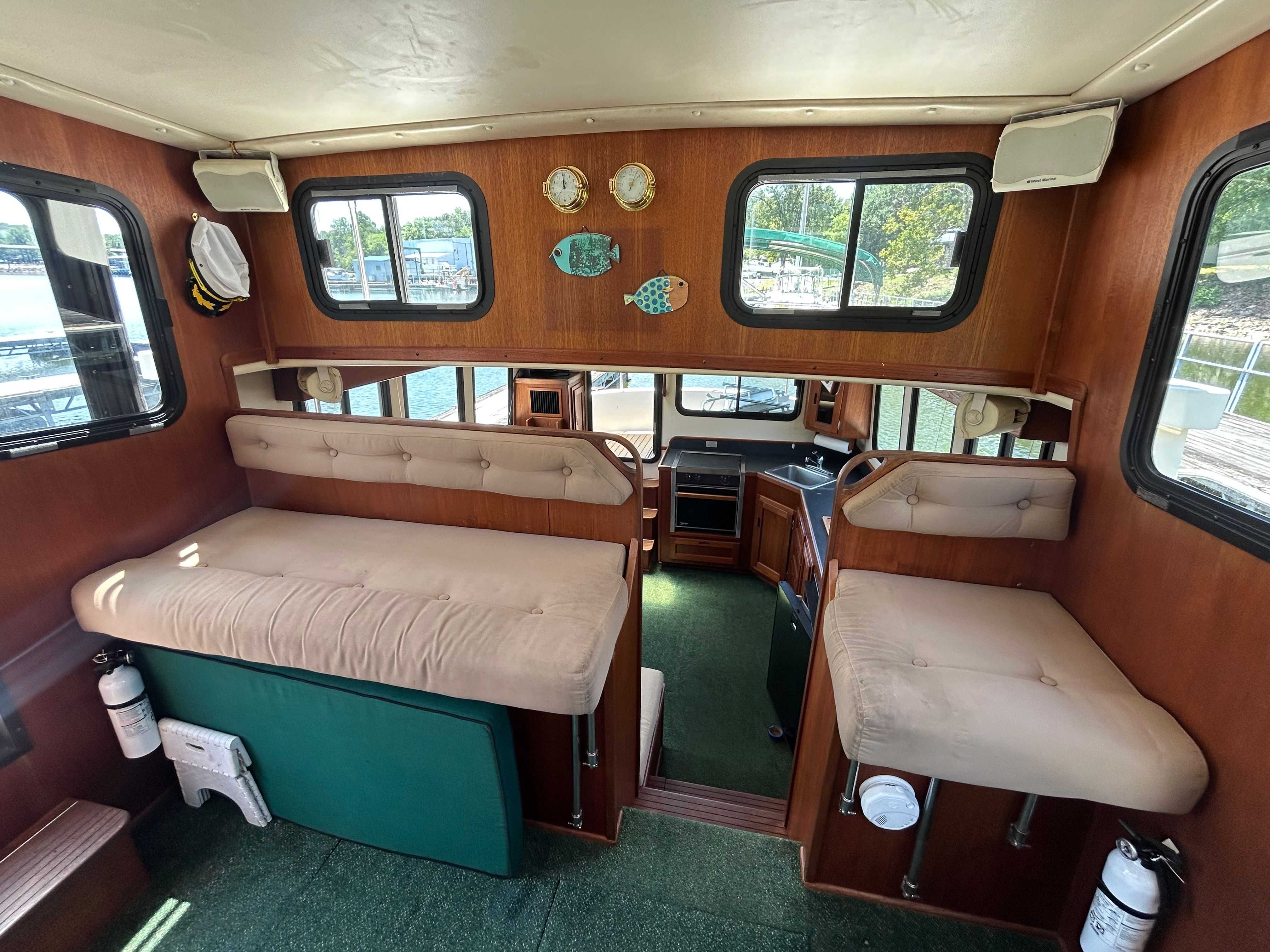 Interior of 2001 Nordic Tug 32 with cushioned seating and wooden accents.