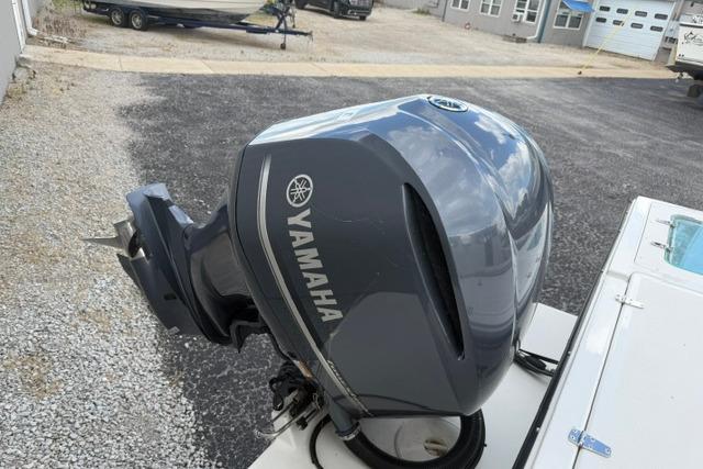 Yamaha outboard motor on a 2016 Parker 2520 Sport Cabin boat, parked on gravel.