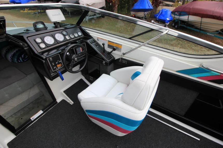 Interior of a 1989 Formula 223 SS boat with white and blue seating.