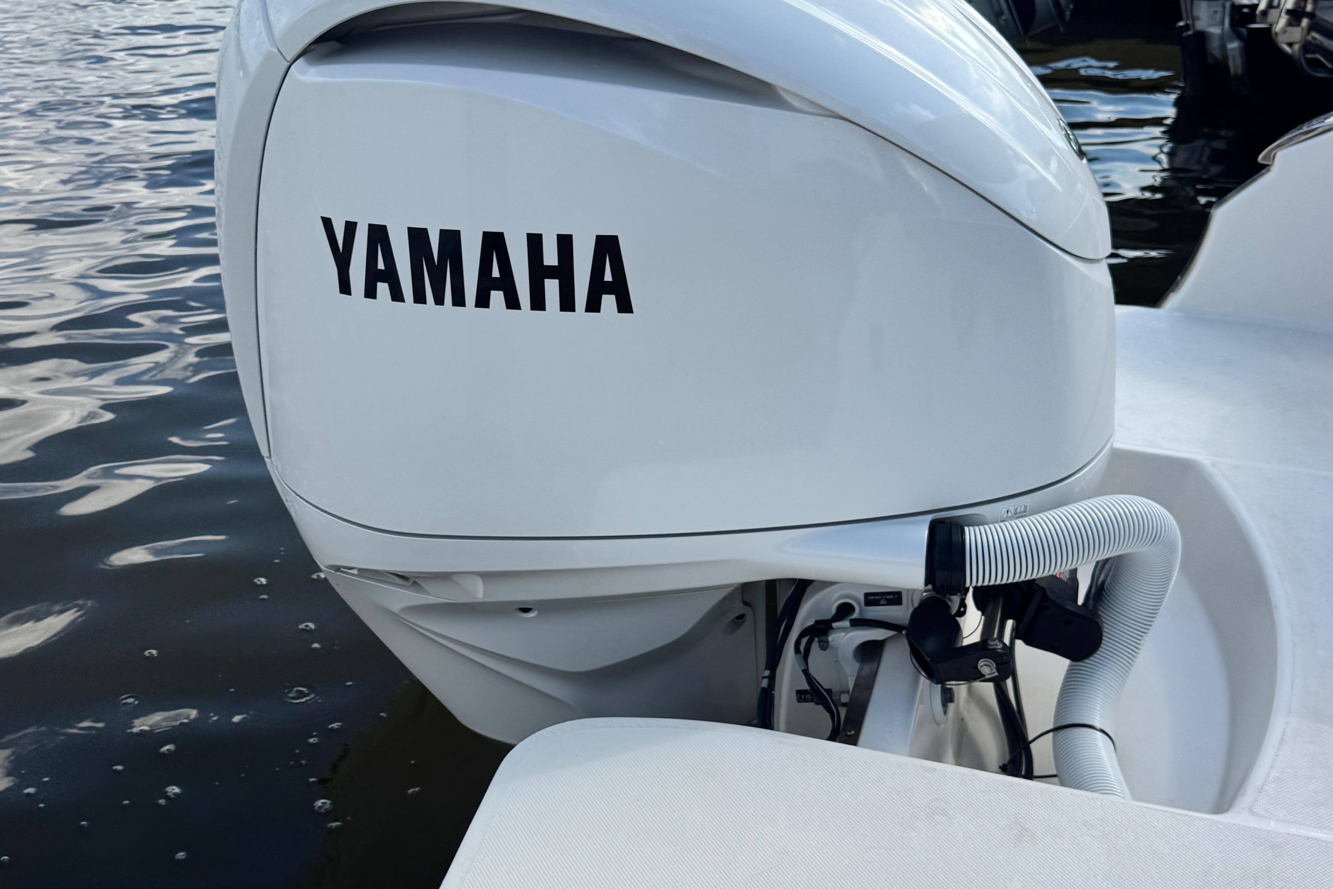 2024 Regal LX6 boat with Yamaha outboard motor on water.