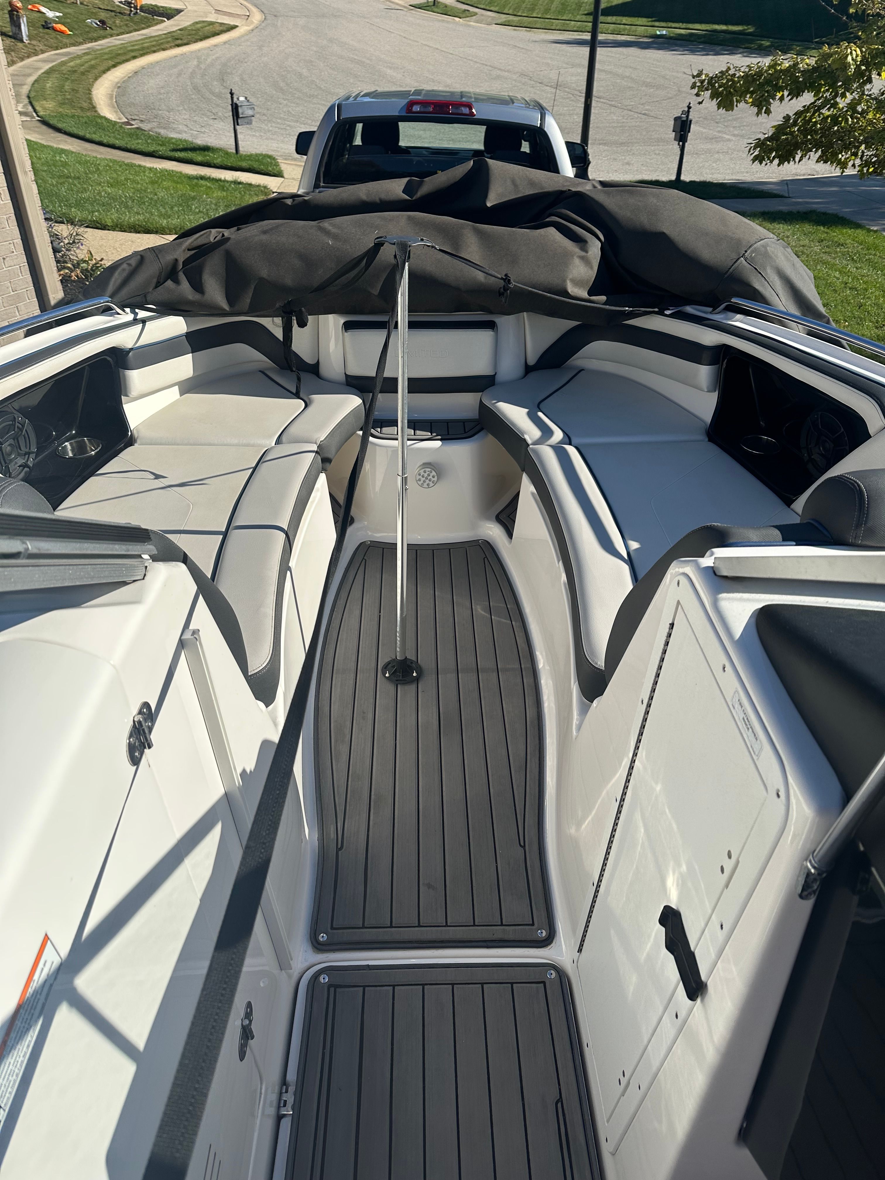 The image shows the cockpit of a 2018 Yamaha 242 Limited S boat with gray flooring.