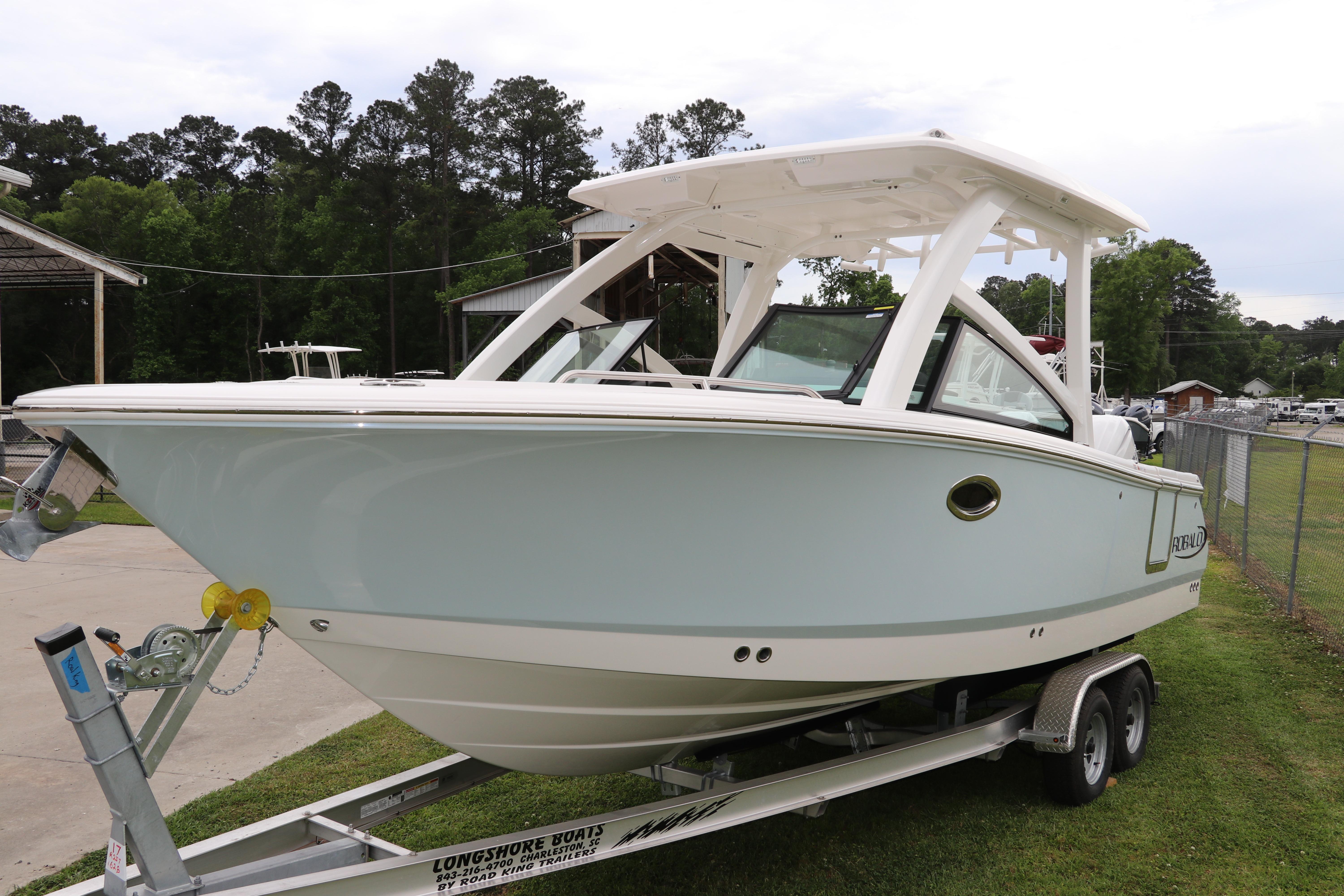 2026 Robalo R257 Dual Console boat on trailer, parked outdoors.