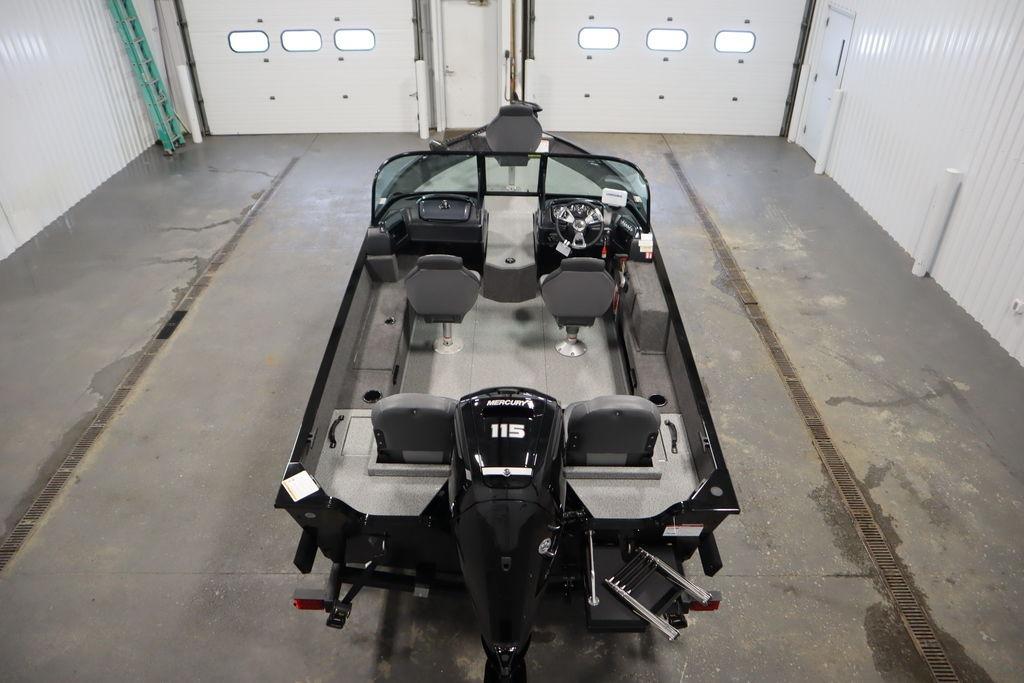 2026 Lowe Fishing Machine 175 in a garage, showcasing interior and motor.