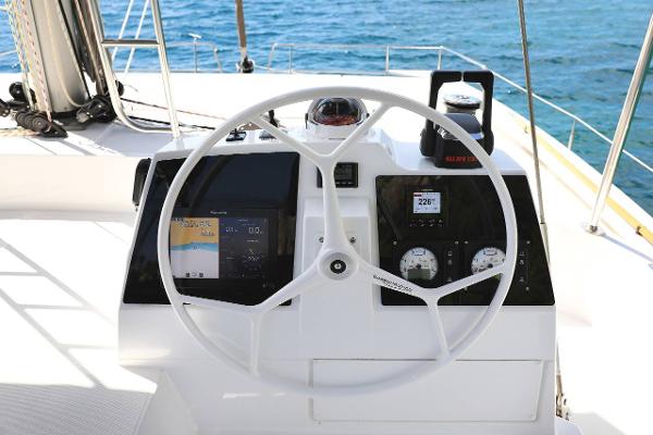 Steering wheel and dashboard of a 2021 Bali 4.8 yacht with navigation instruments.