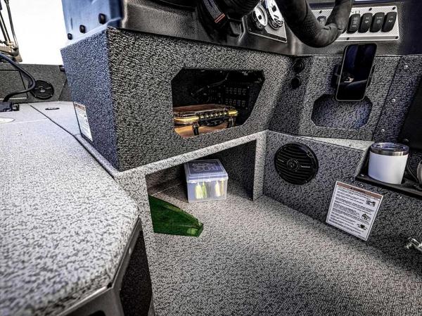 Interior view of 2026 Lund 1875 Impact XS boat cockpit with storage compartments.