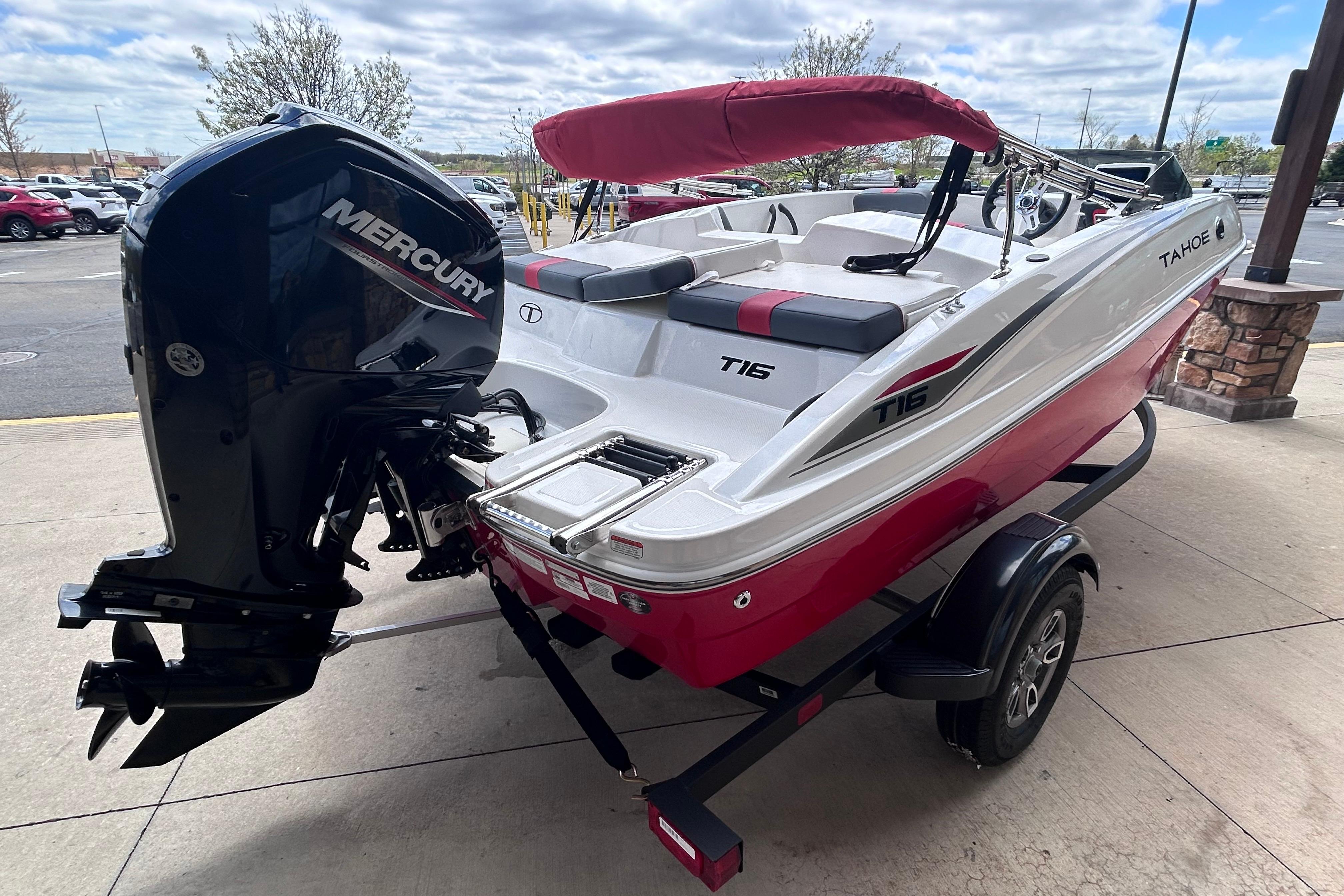 2026 Tahoe T16 boat with Mercury engine, red and white design, on a trailer.