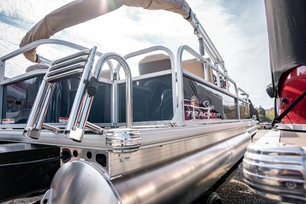 2025 Sun Tracker BASS BUGGY 18 pontoon boat, sleek design, outdoor setting.
