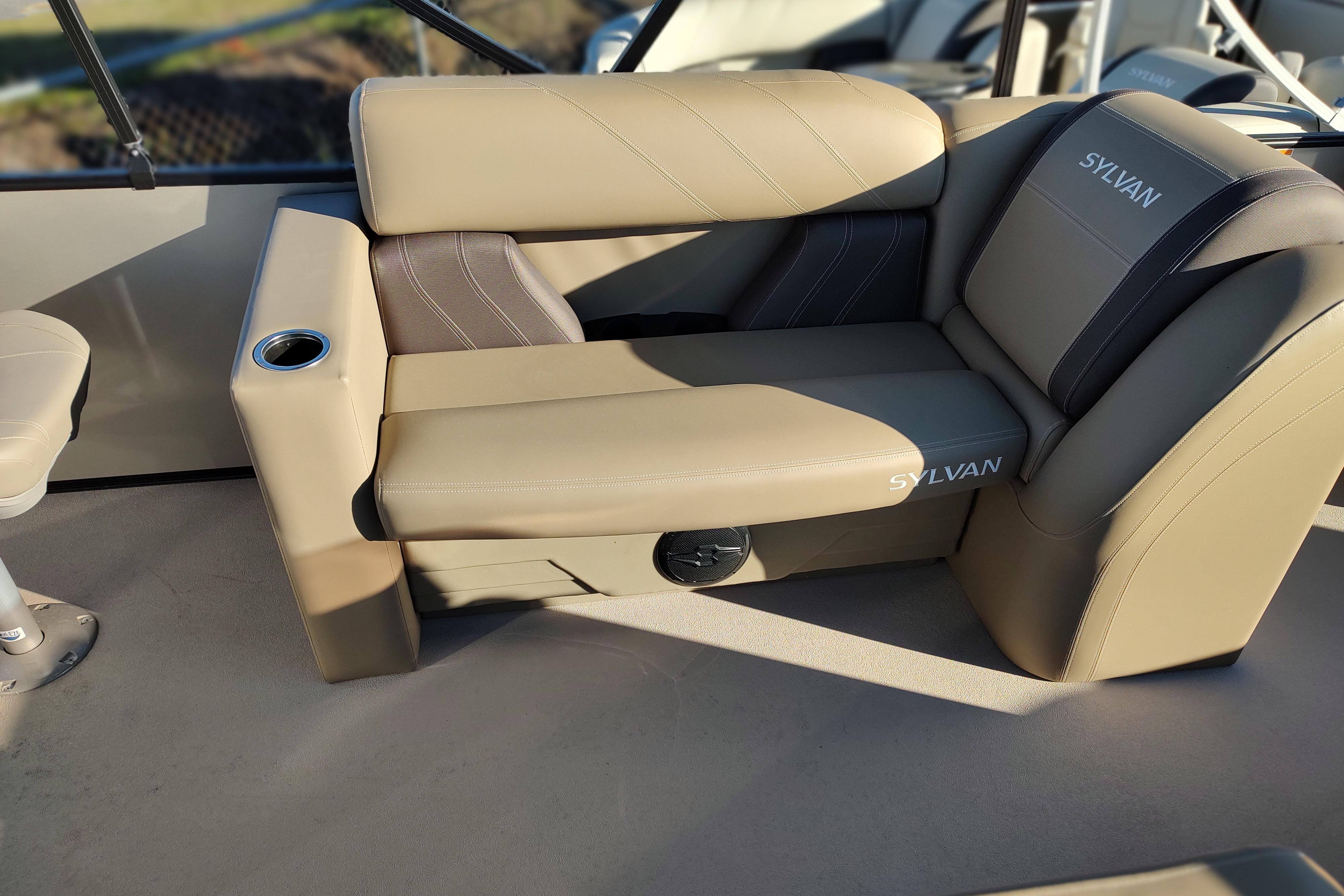Luxurious seating on 2026 Sylvan Mirage 820 PARTY FISH boat, featuring beige upholstery and cup holder.