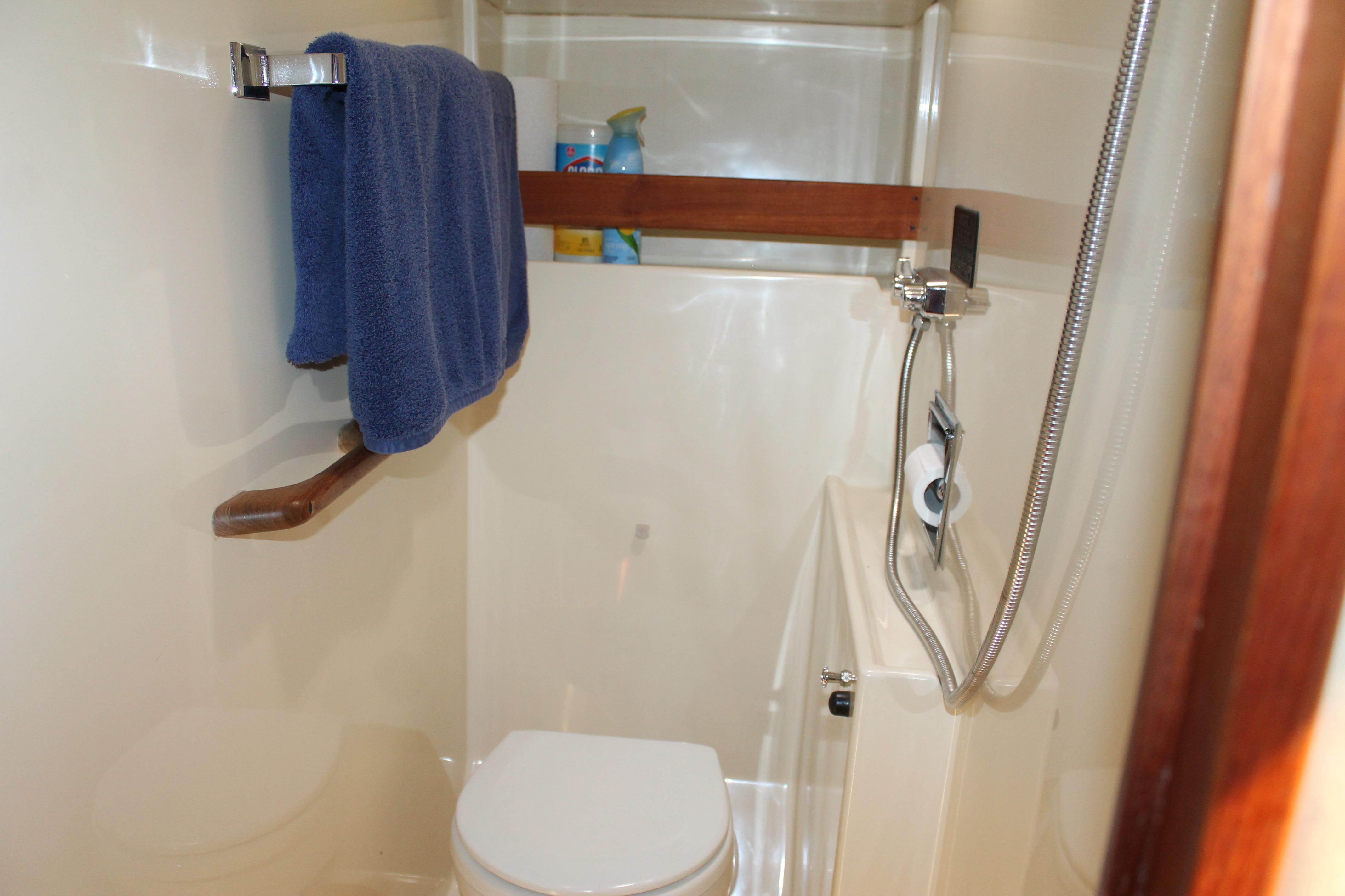 Bathroom interior of 1987 Chris-Craft 427 Catalina yacht with shower and towel rack.