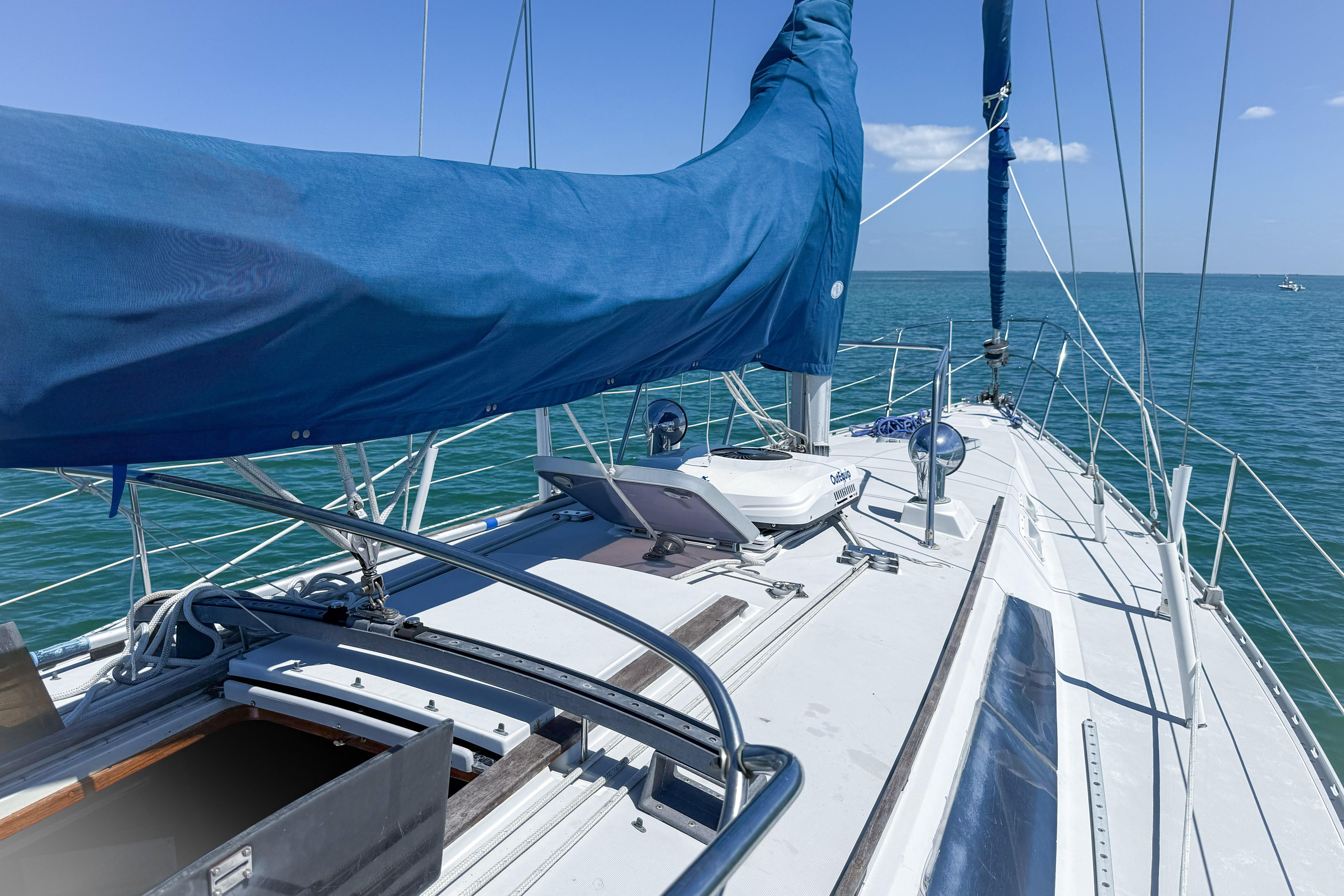 1988 Oday 40 sailboat deck with blue sail cover on open water.