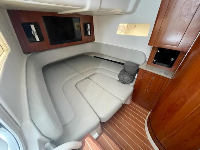 Luxurious interior cabin of 2020 Regulator 41 boat with leather seating and wooden cabinetry.
