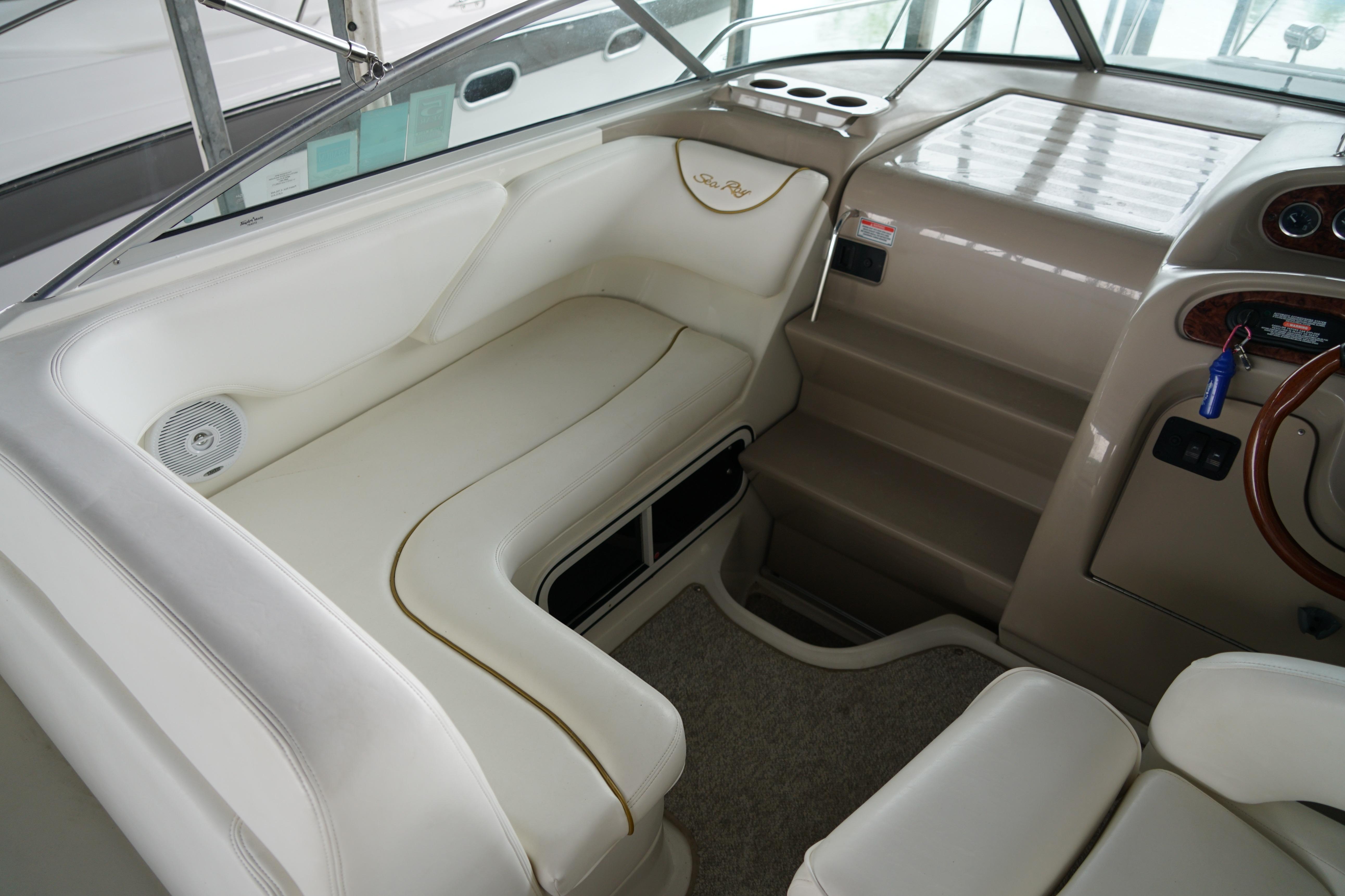 Interior of 2002 Sea Ray Sundancer 260 boat with white seating and helm area.