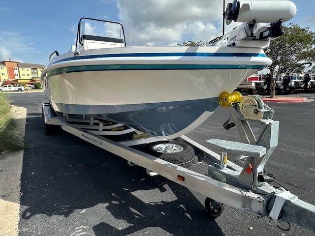 2025 Ranger 2360 Bay boat on trailer, parked outdoors under cloudy sky.