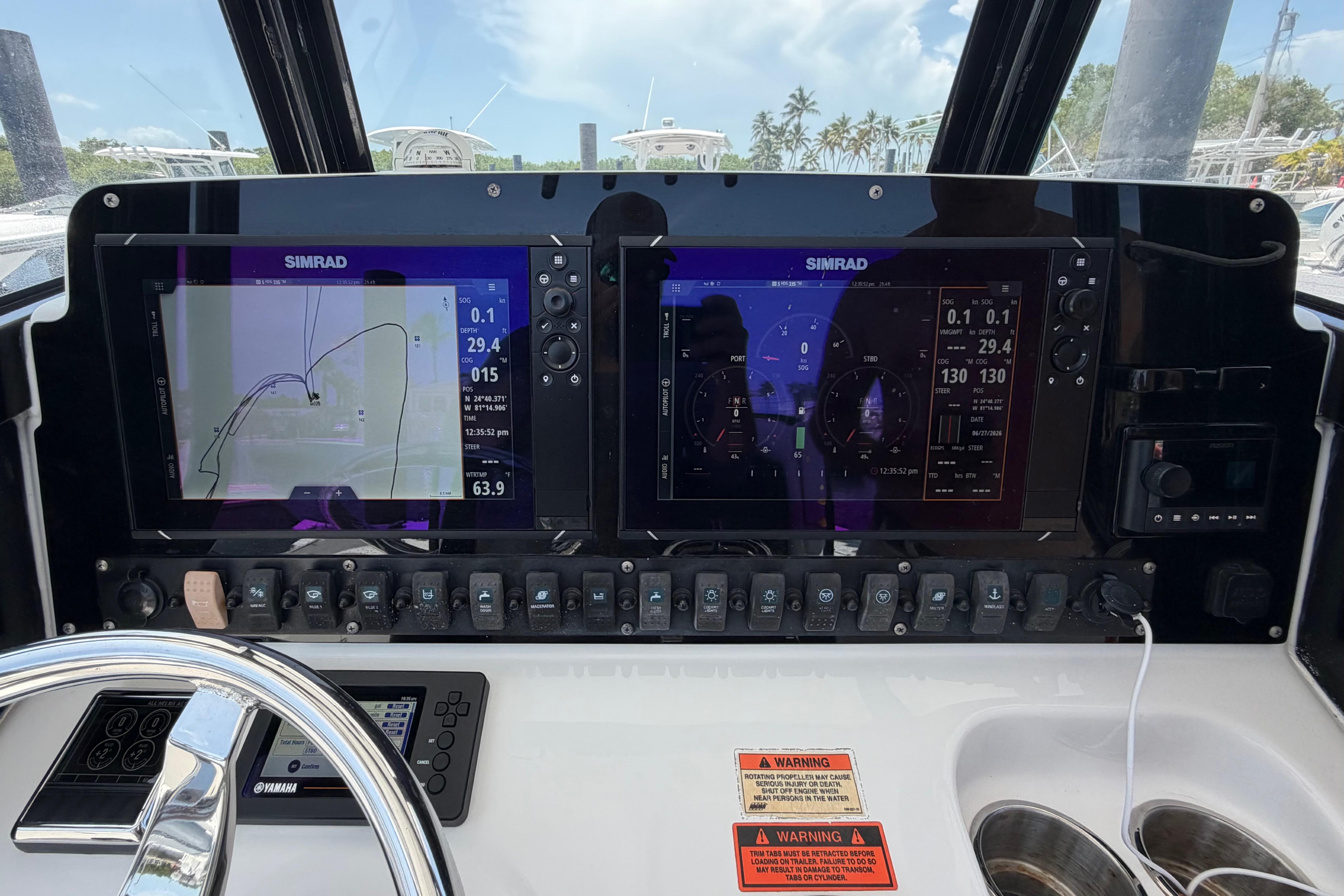 2019 Sea Hunt Gamefish 27 dashboard with dual Simrad displays and control panel.
