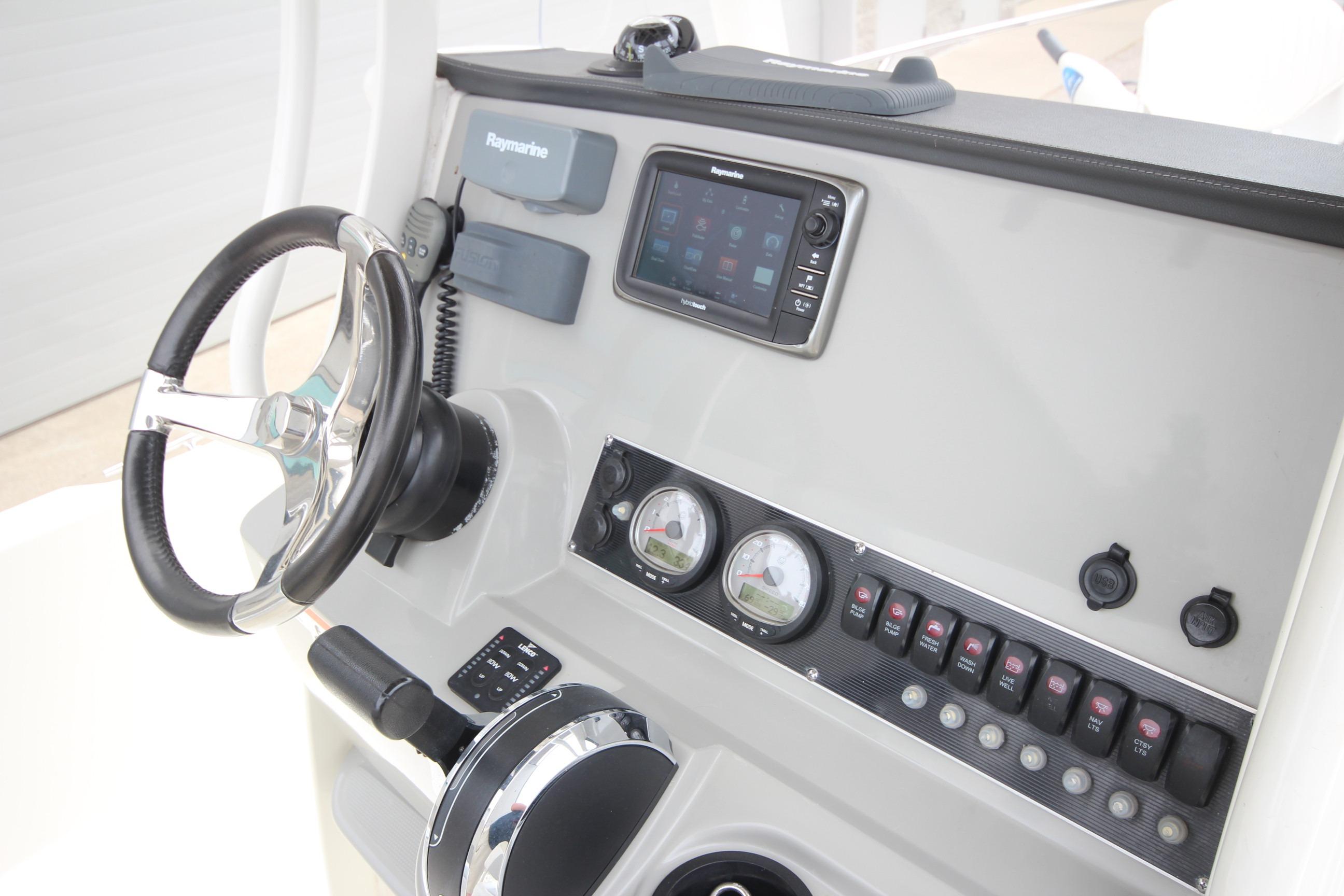 2014 Boston Whaler 210 Dauntless dashboard with steering wheel and navigation controls.