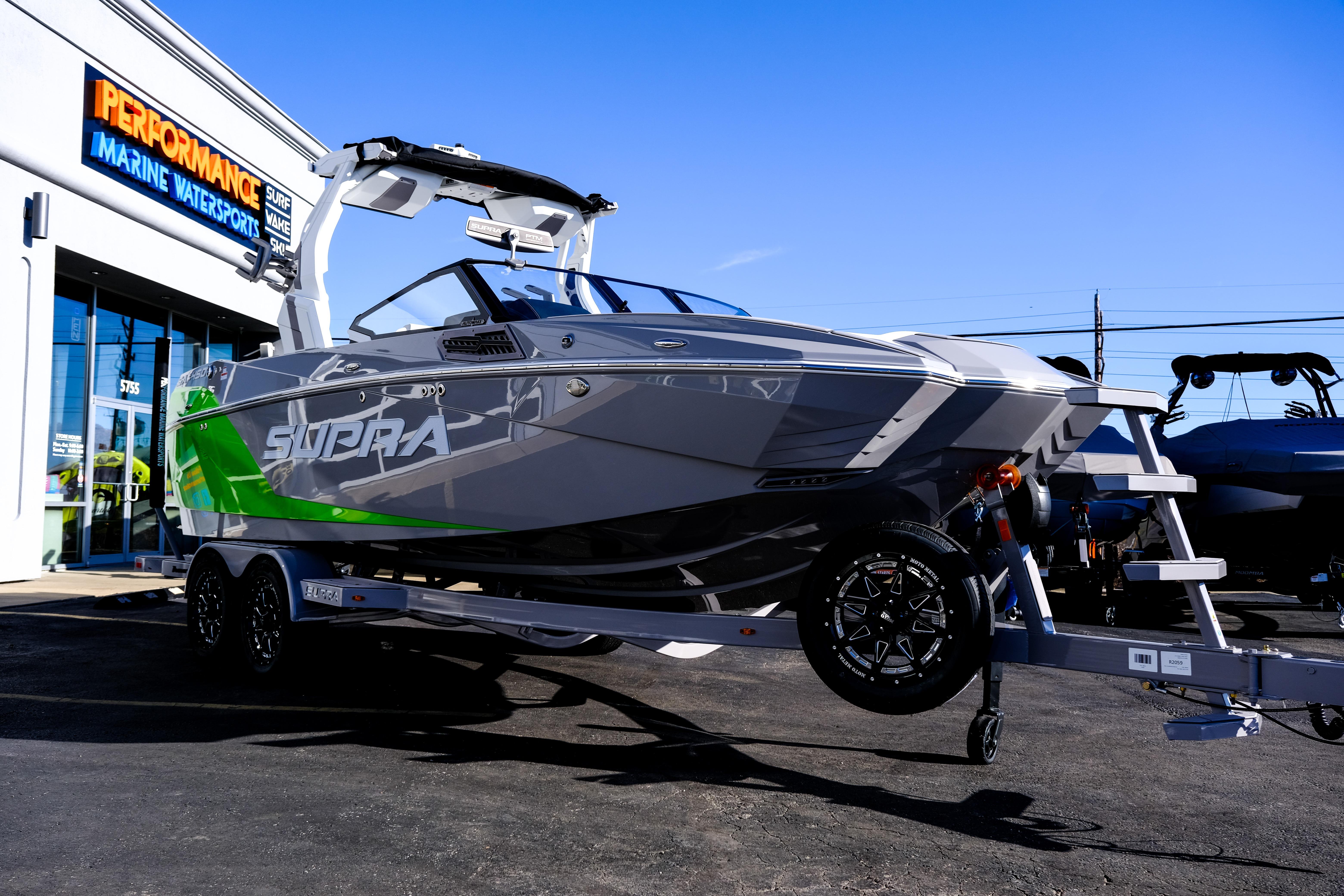 2024 Supra SA 450 boat on trailer outside Performance Marine Watersports store.