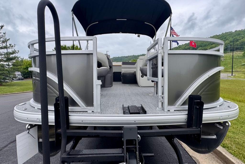 2026 Sun Tracker Fishin' Barge 20 DLX pontoon boat on trailer, ready for adventure.