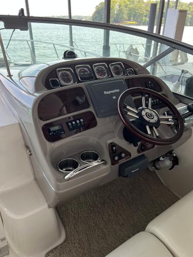 Helm of a 2008 Chaparral Signature 310 boat by the water.