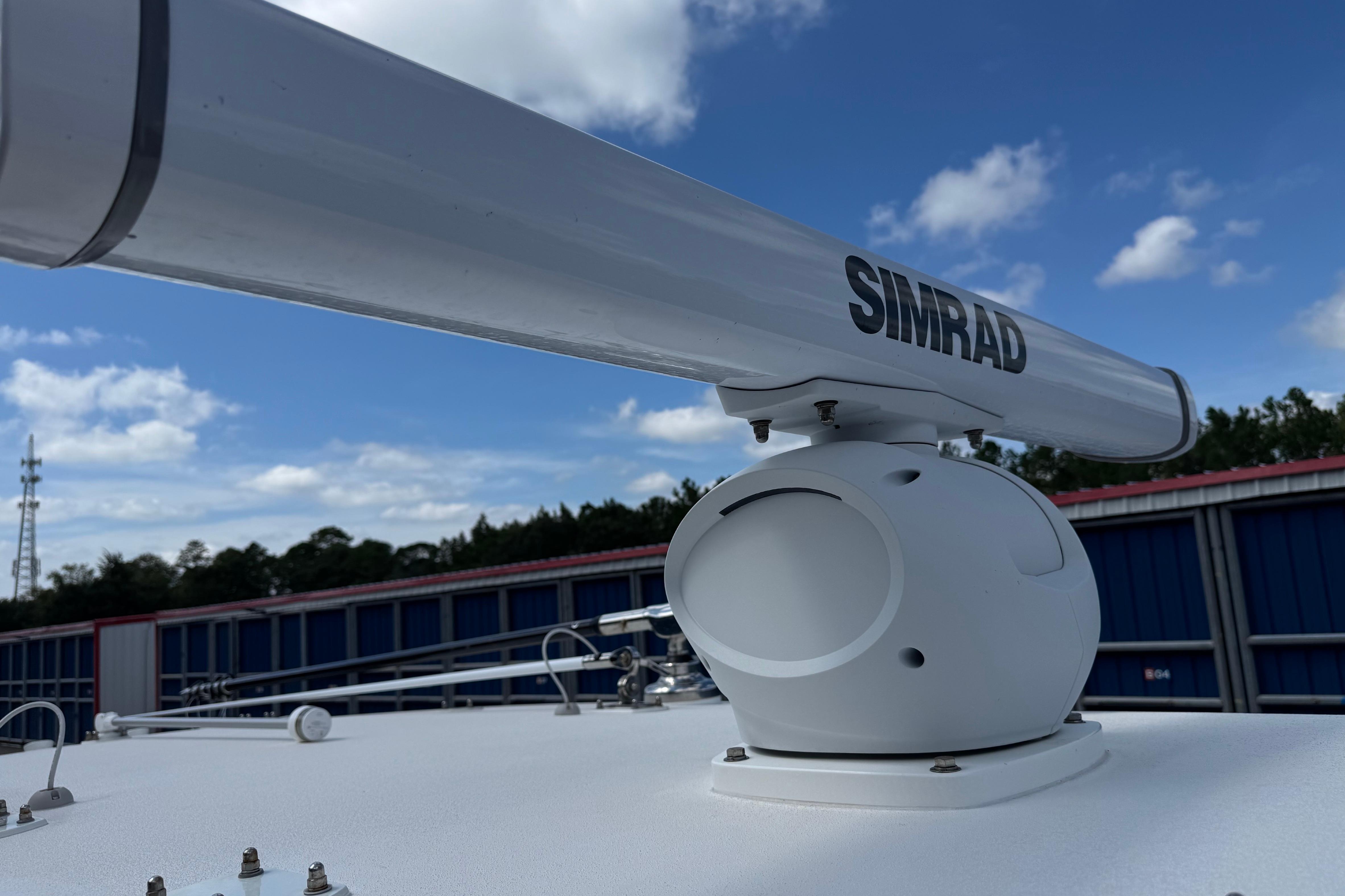 Simrad radar on 2024 SeaVee 32Z boat under blue sky.