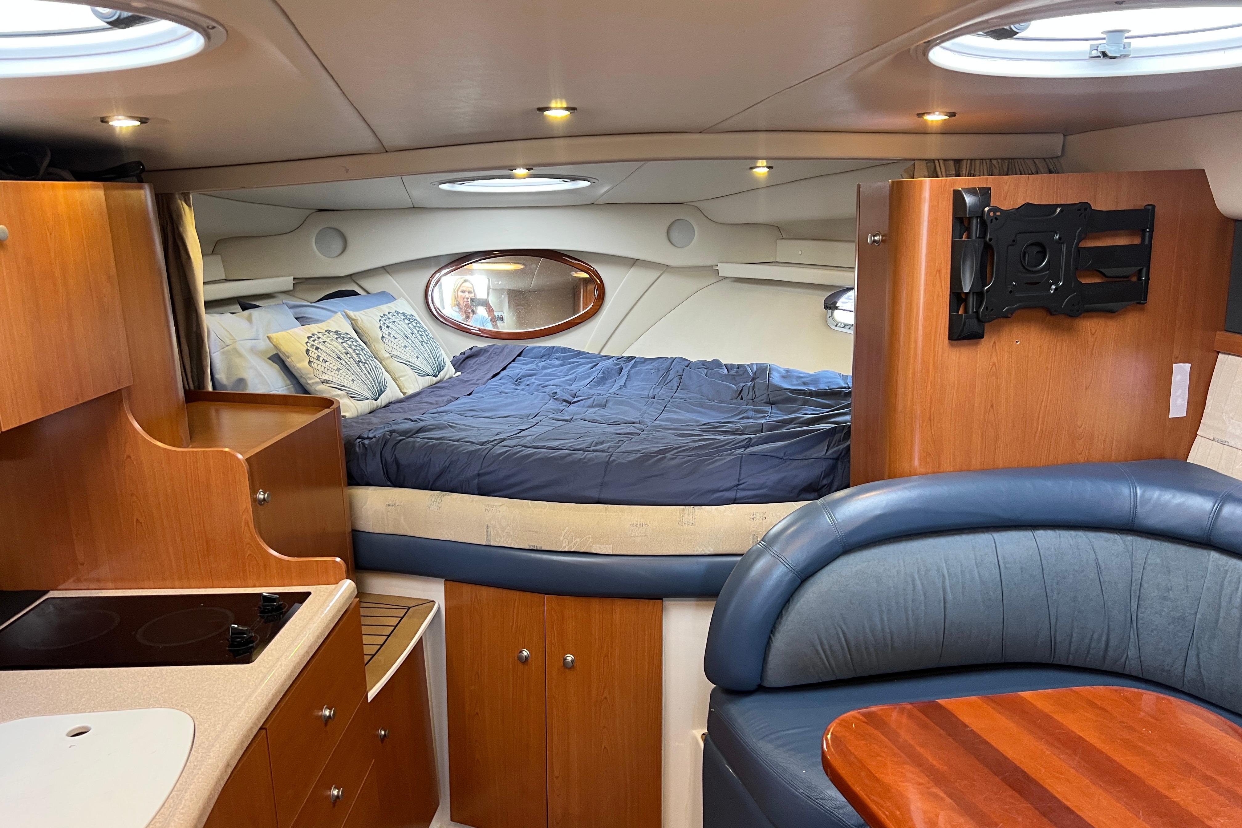 Interior of 2002 Four Winns 328 Vista boat with cozy bed and kitchenette.