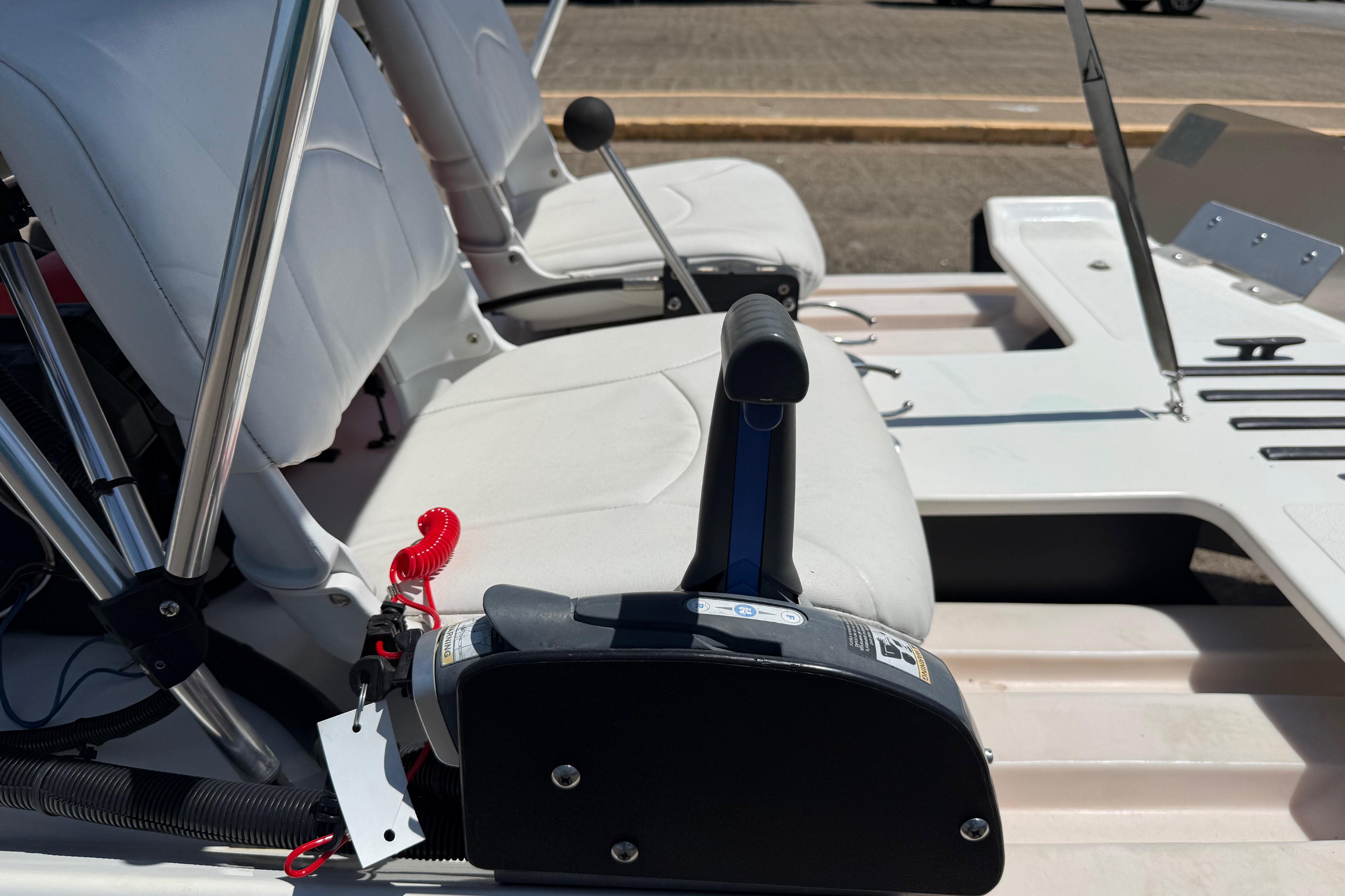 2016 CraigCat E2 Elite boat interior with white seats and control lever.