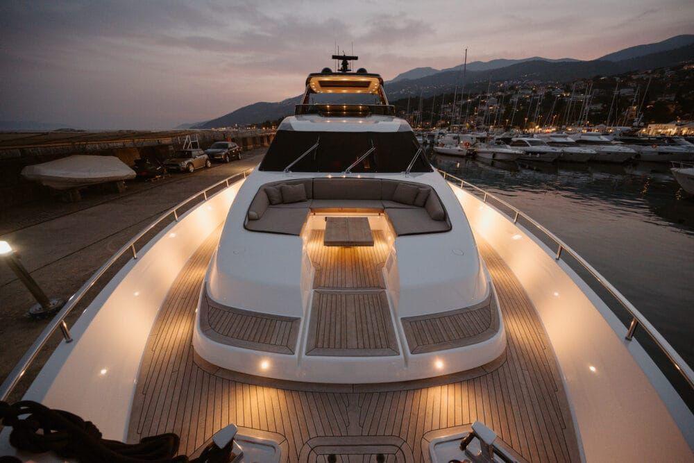 Sanlorenzo SL86 2016 yacht at sunset, docked in a marina with elegant deck lighting.