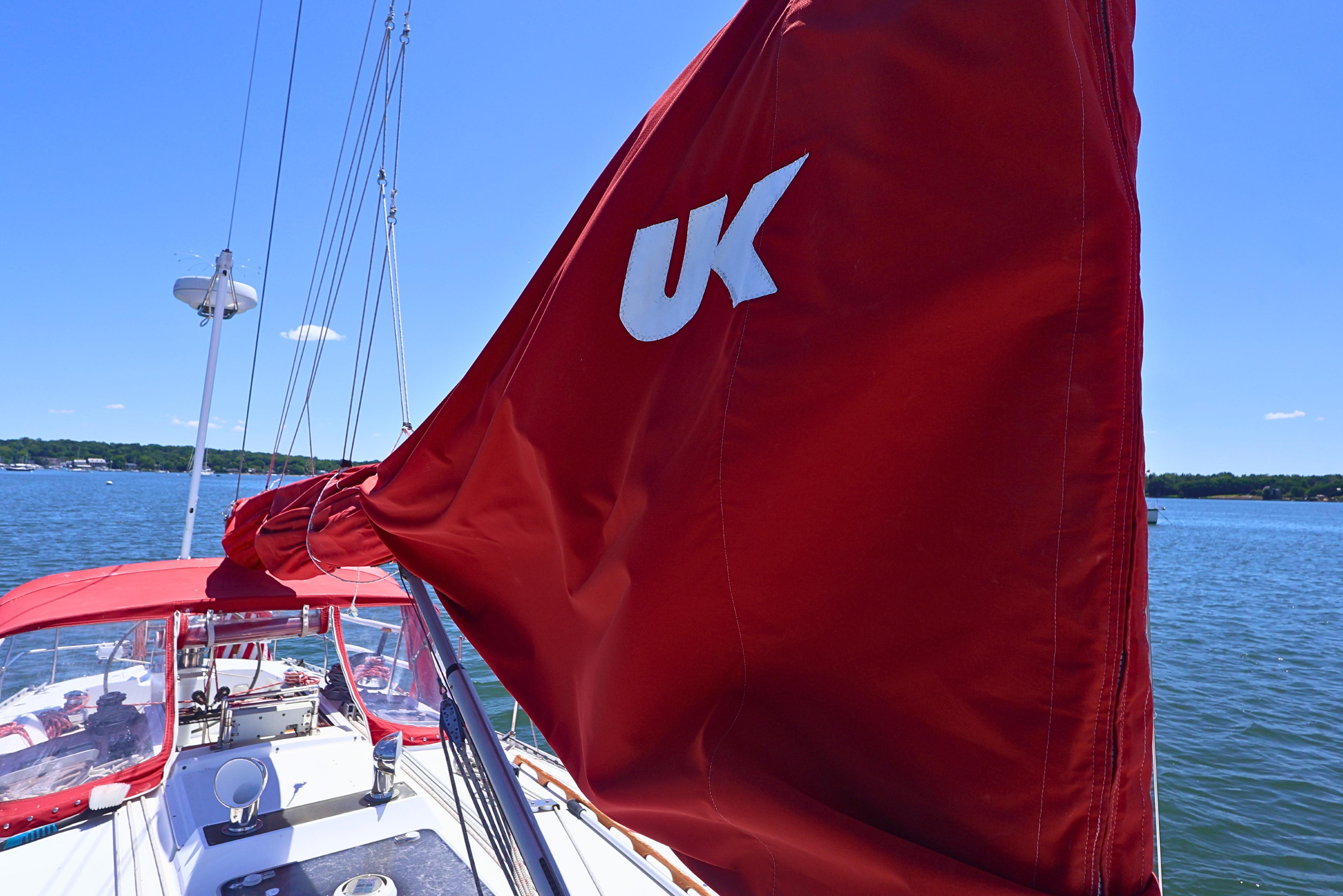 Red sail on 1989 J Boat J 40, sailing on a sunny day.