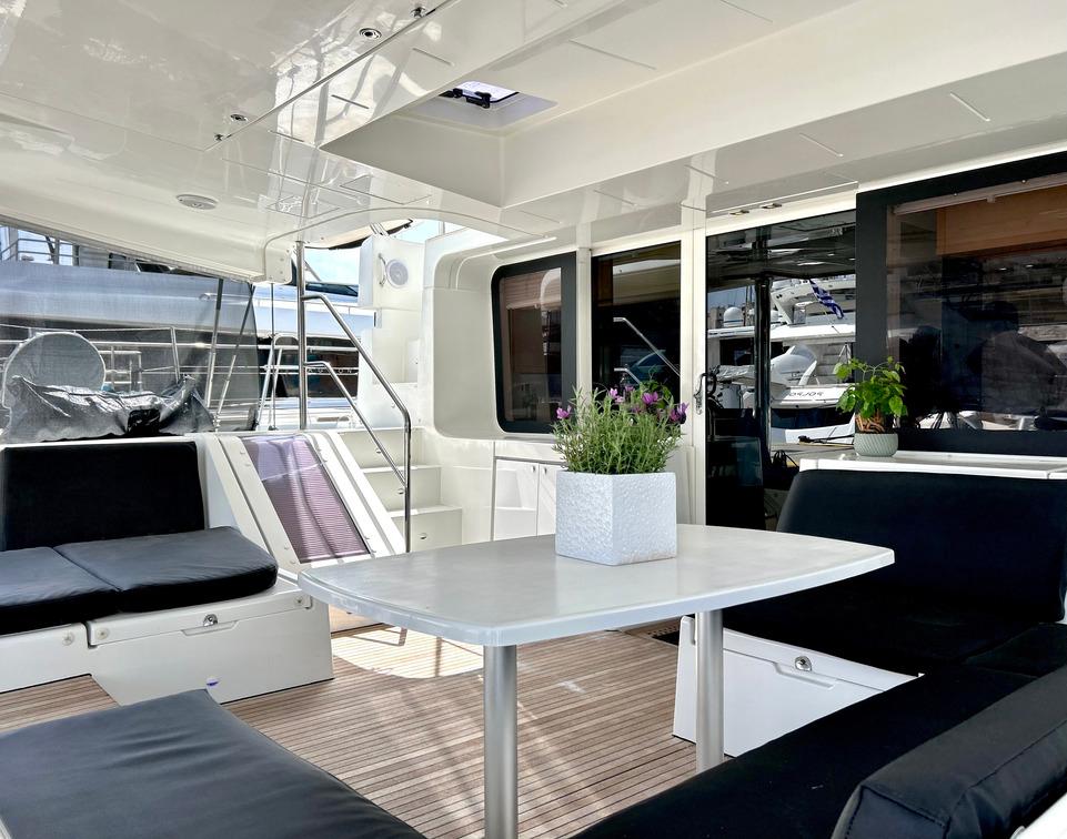 Spacious interior of 2013 Lagoon 52 yacht with modern seating and table.
