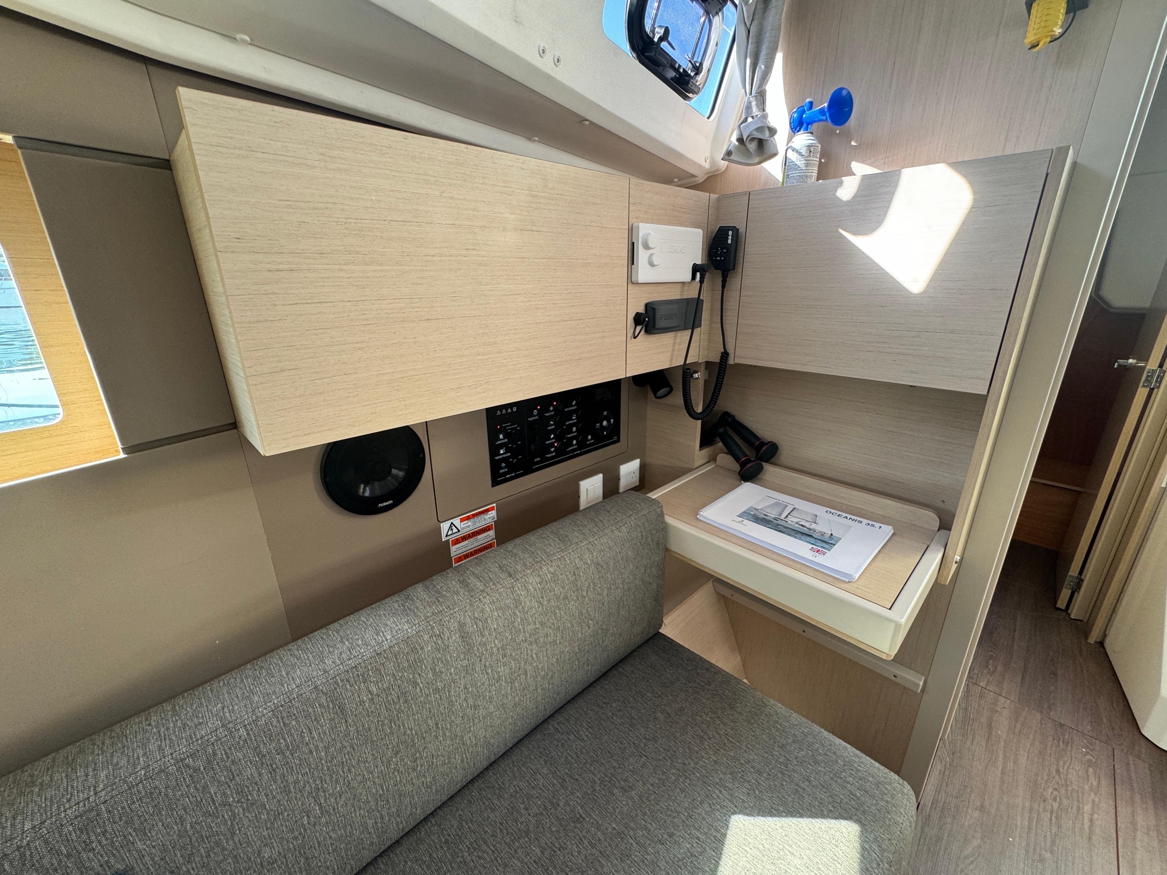 Interior of 2021 Beneteau Oceanis 35.1 yacht with seating and navigation station.