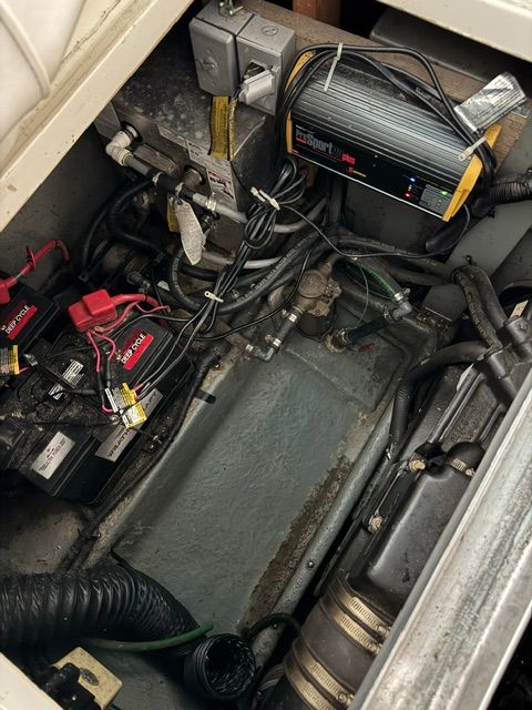 View of a 1992 Sea Ray 290 Sundancer engine compartment with batteries and wiring.