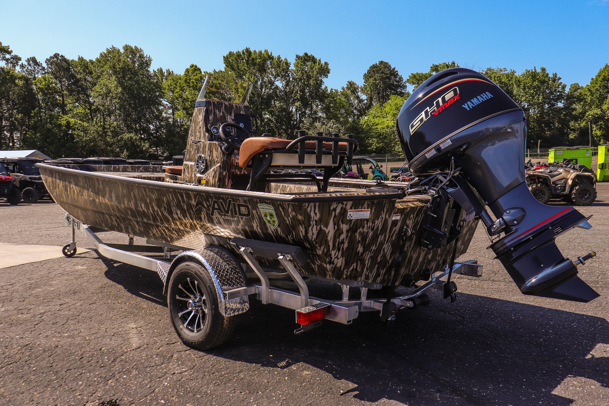 Avid 20 Rogue CC 2027 on a trailer, with Yamaha engine, parked in a wooded area.