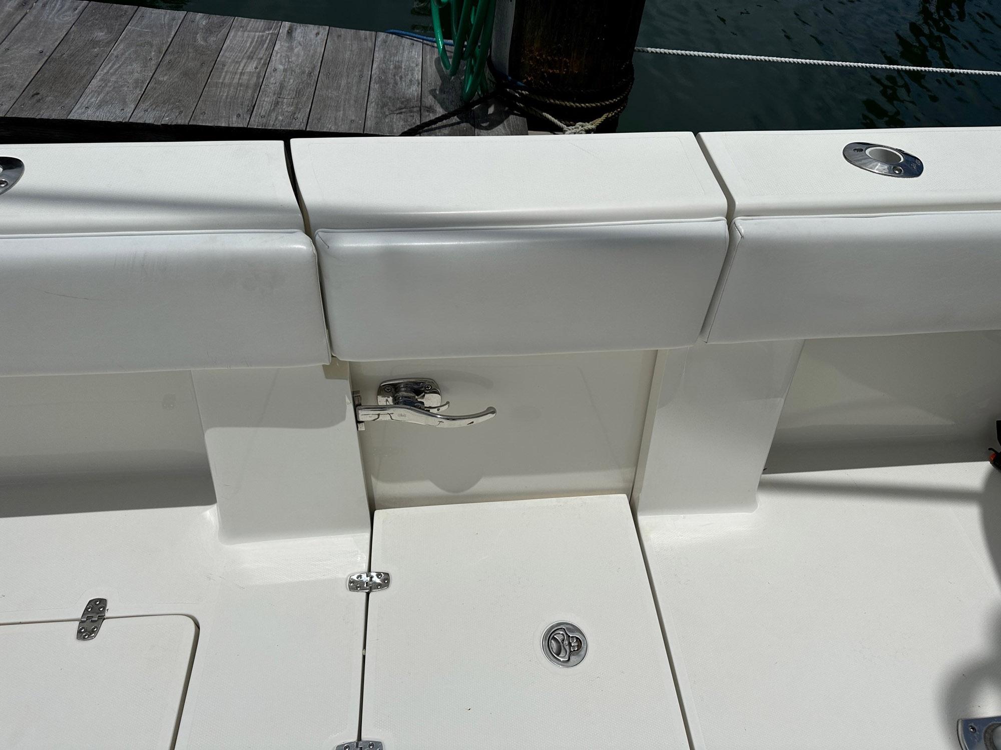 2018 SeaVee 390Z boat deck with white cushioned seating and storage compartments.