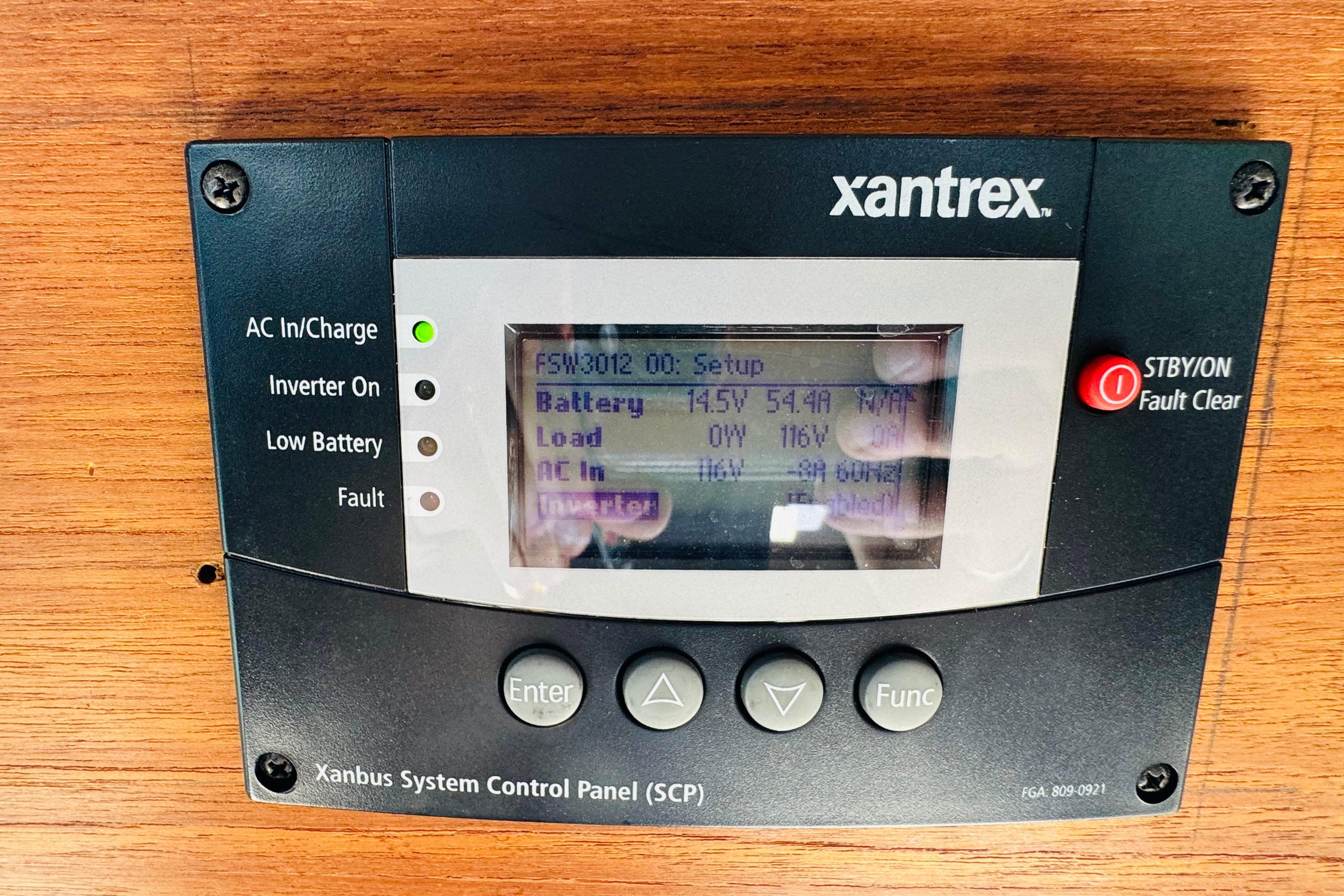 Xantrex control panel on 1996 Nordic Tug 32, displaying battery and load information.