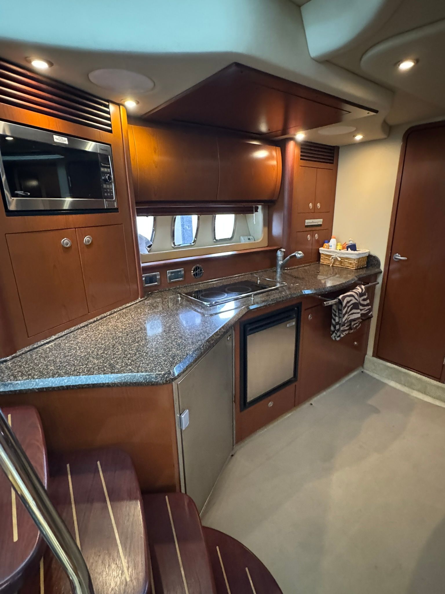 Interior of the 2007 Sea Ray 40 Sundancer with kitchen, sink, and microwave.