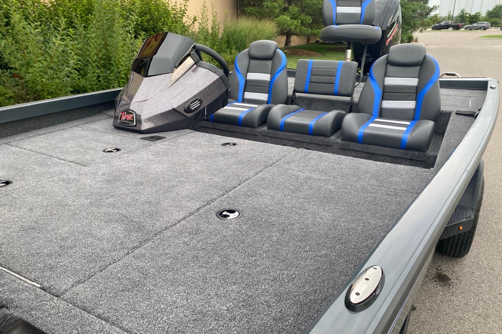 2026 Ranger RT188P boat interior with gray carpet and blue-accented seats.